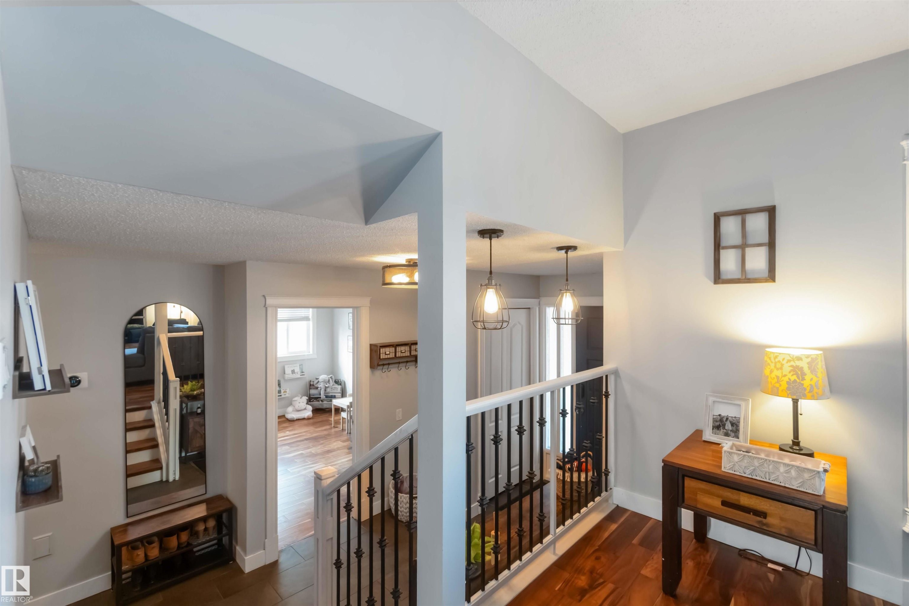 Corridor featuring an upstairs landing and dark wood-style flooring - 6 Garraway Pl, St. Albert, AB - Indoor Photo Showing Other Room