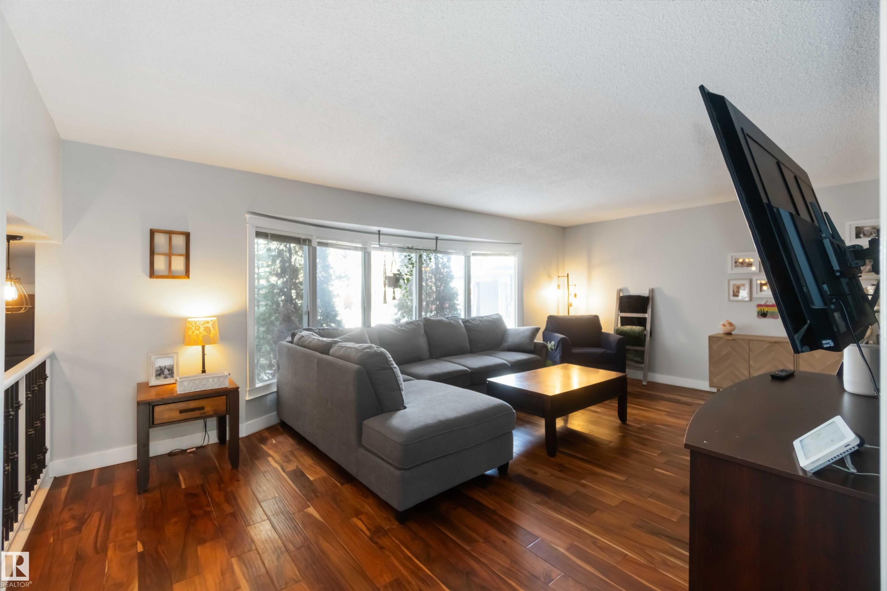 Living area featuring dark wood-style floors - 6 Garraway Pl, St. Albert, AB - Indoor Photo Showing Living Room