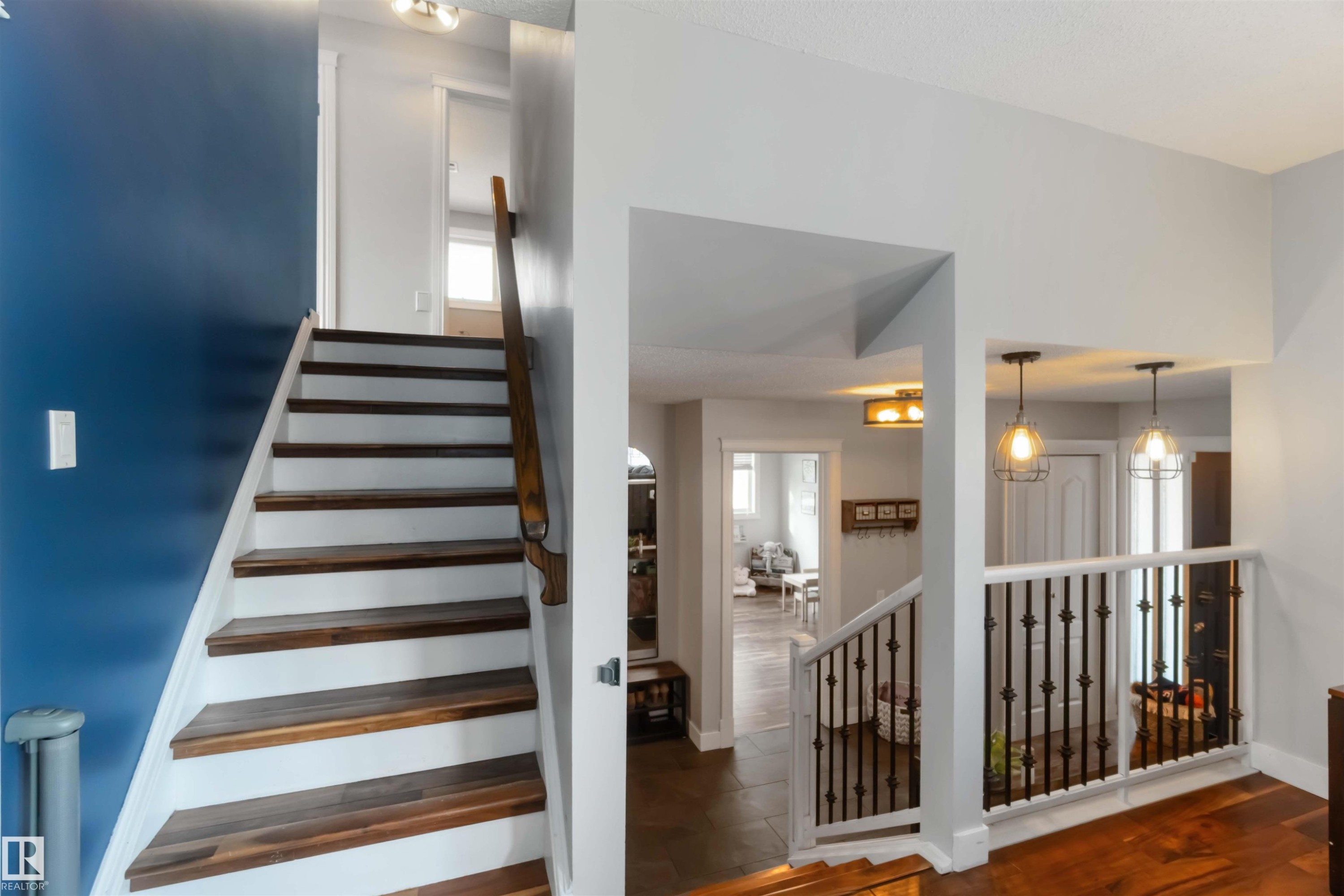 Staircase featuring wood finished floors - 6 Garraway Pl, St. Albert, AB - Indoor Photo Showing Other Room