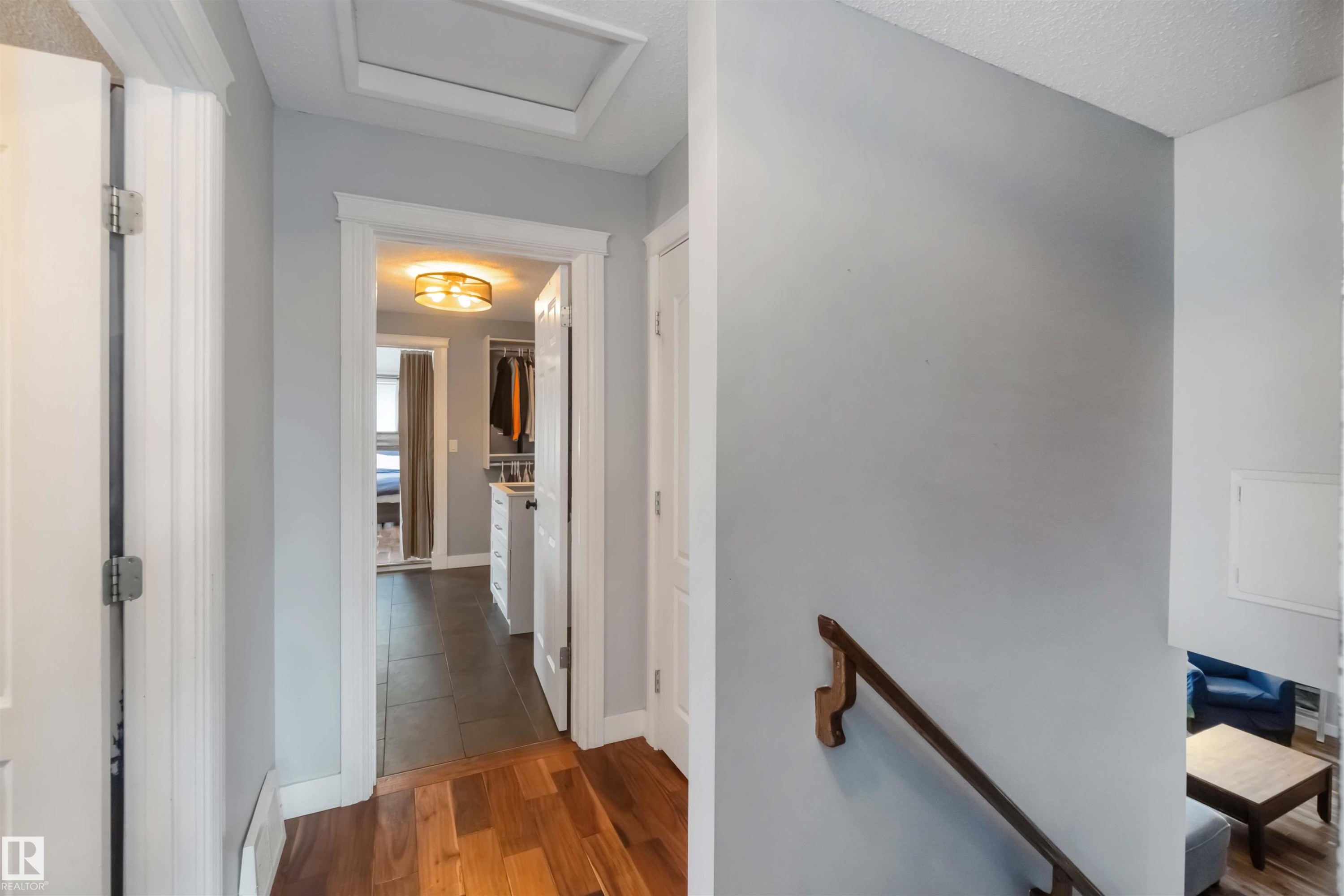 Hallway featuring an upstairs landing, dark wood-type flooring, and a textured ceiling - 6 Garraway Pl, St. Albert, AB - Indoor Photo Showing Other Room