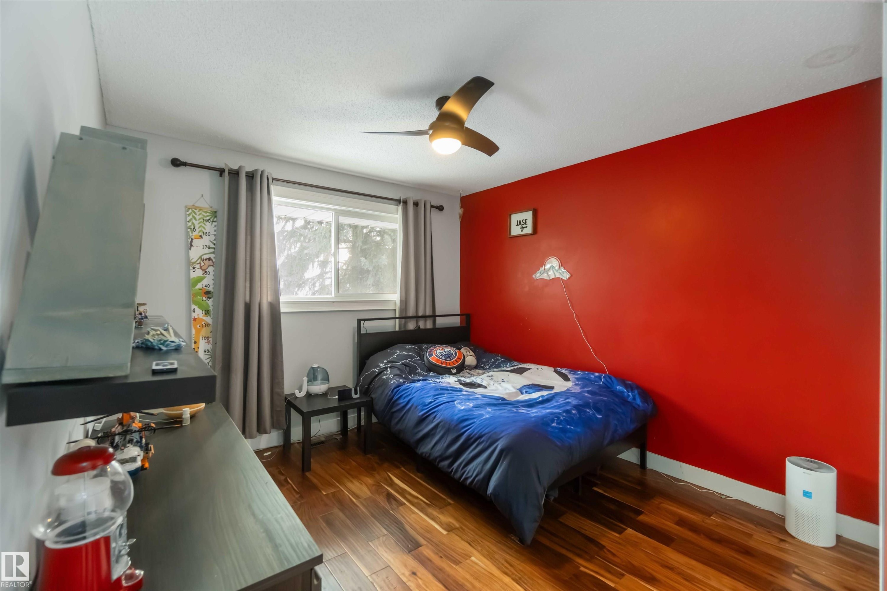 Bedroom with dark wood finished floors and ceiling fan - 6 Garraway Pl, St. Albert, AB - Indoor Photo Showing Bedroom