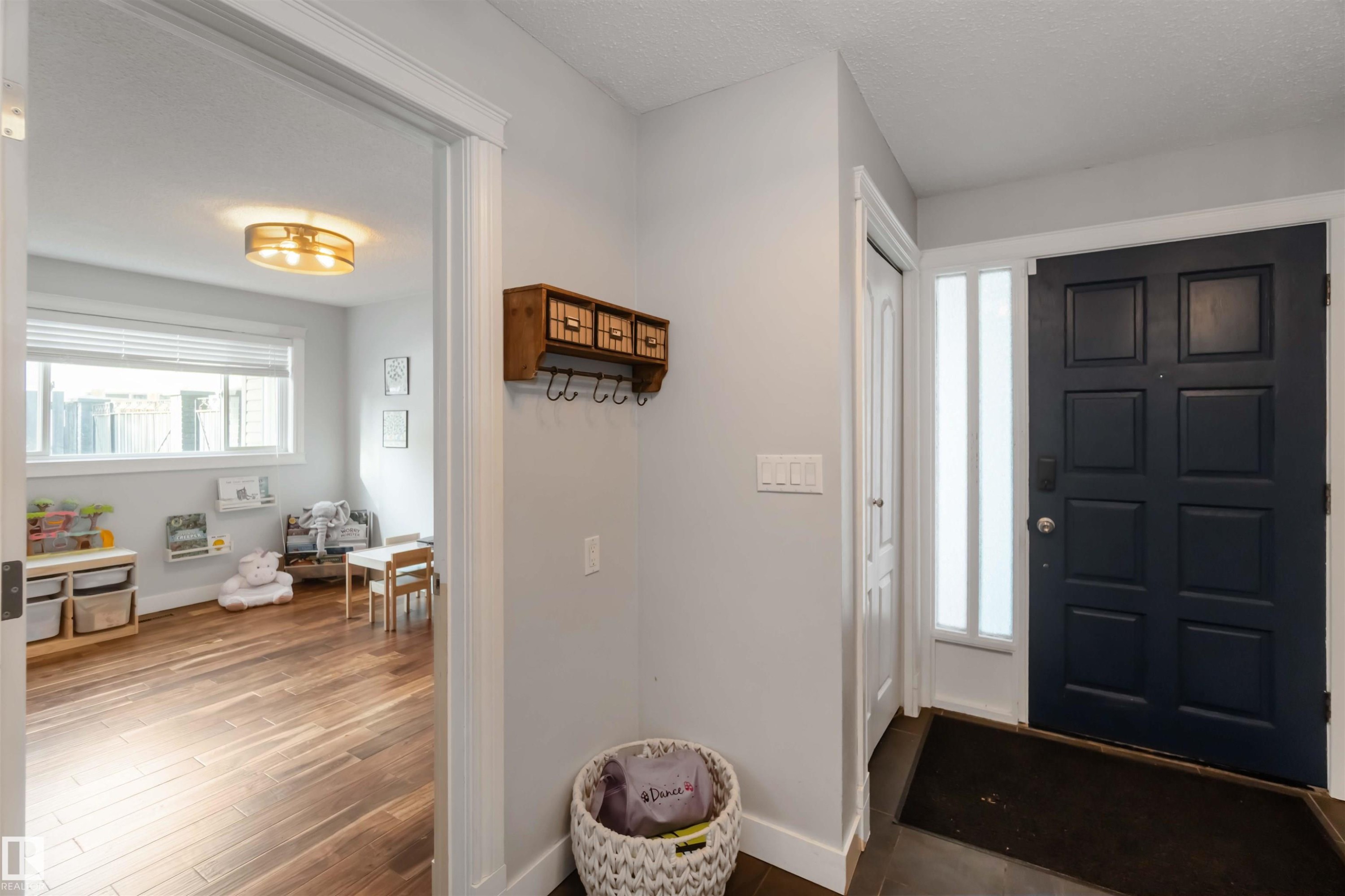 Foyer with dark wood-type flooring and baseboards - 6 Garraway Pl, St. Albert, AB - Indoor Photo Showing Other Room