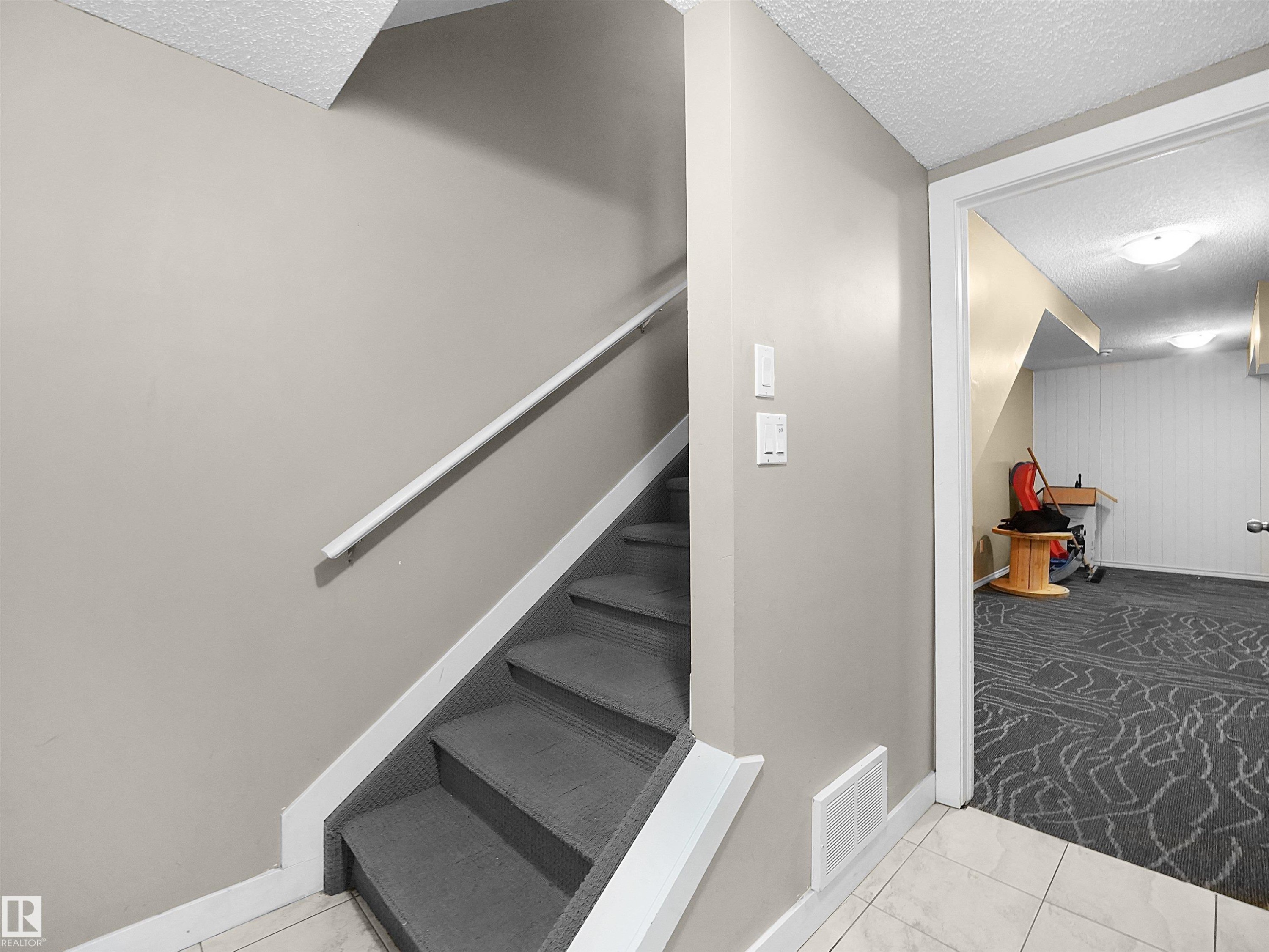 Staircase with a textured ceiling and carpet flooring - 791 Abbottsfield Road, Edmonton, AB - Indoor Photo Showing Other Room