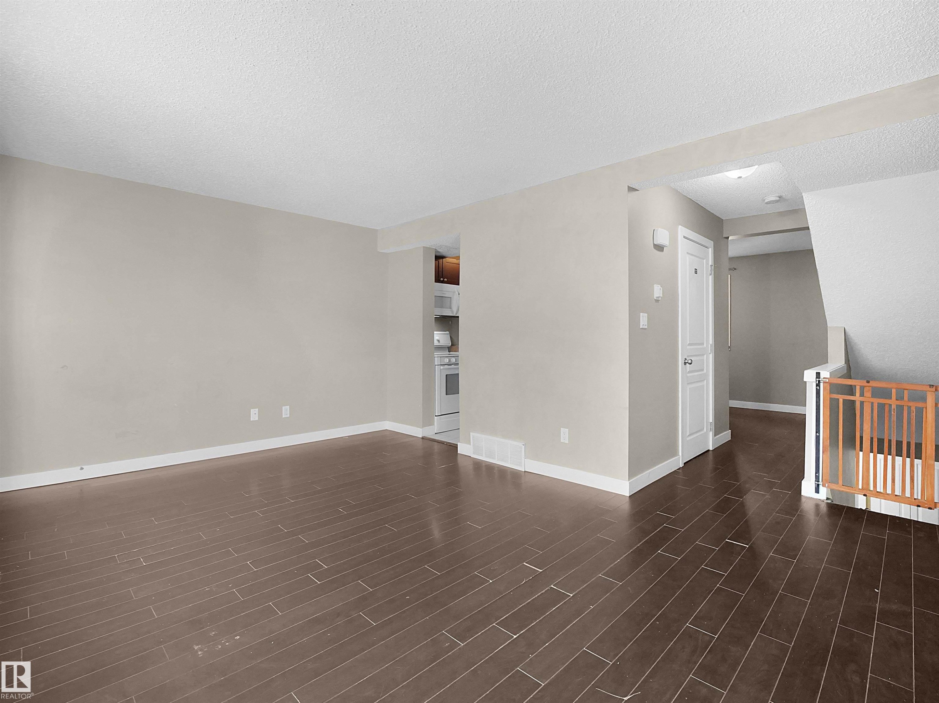 Empty room featuring a textured ceiling and dark wood-style flooring - 791 Abbottsfield Road, Edmonton, AB - Indoor Photo Showing Other Room