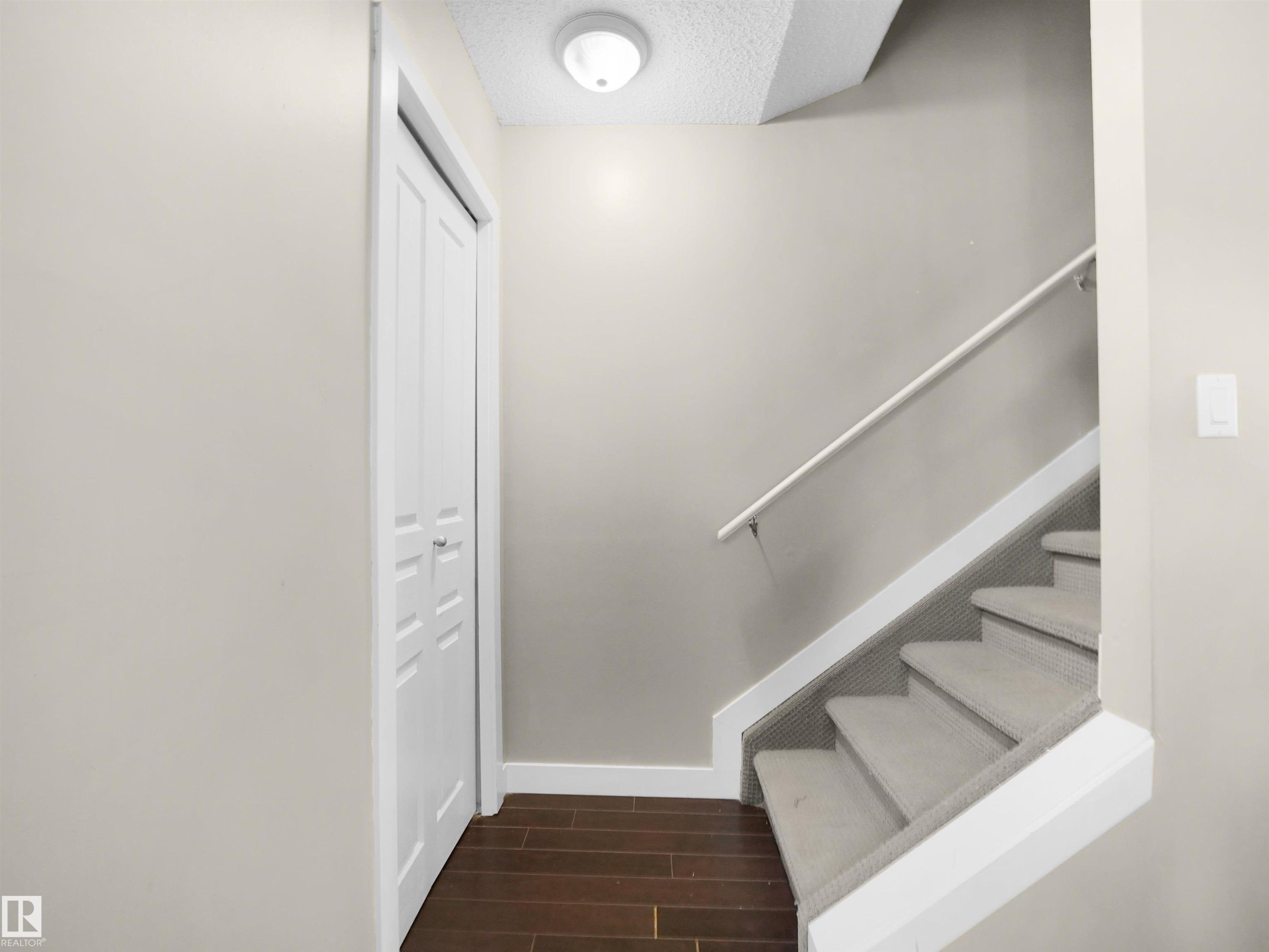 Stairway featuring wood finish floors and a textured ceiling - 791 Abbottsfield Road, Edmonton, AB - Indoor Photo Showing Other Room