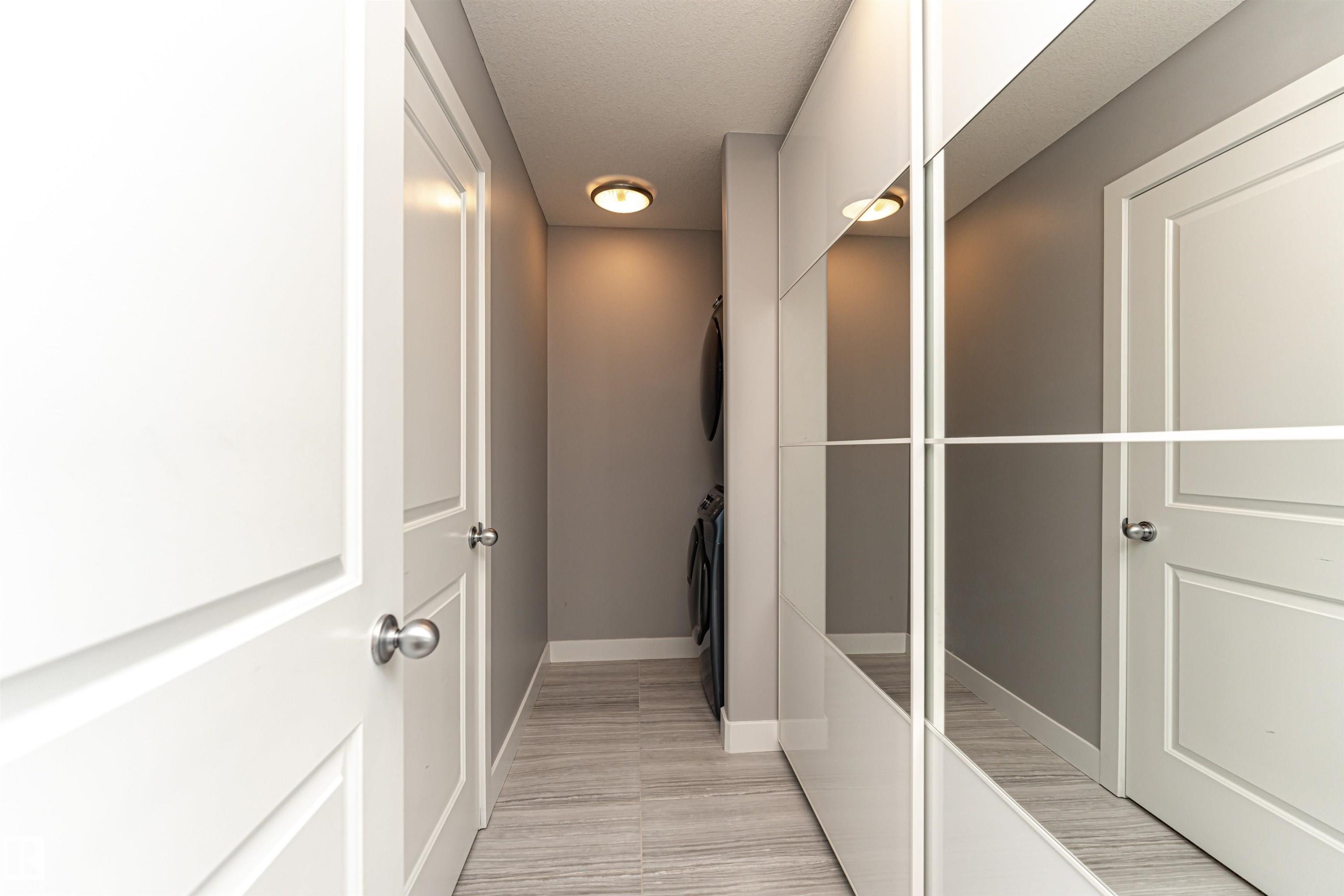 Corridor featuring baseboards and washer / dryer - 3611 Keswick Boulevard, Edmonton, AB - Indoor Photo Showing Other Room