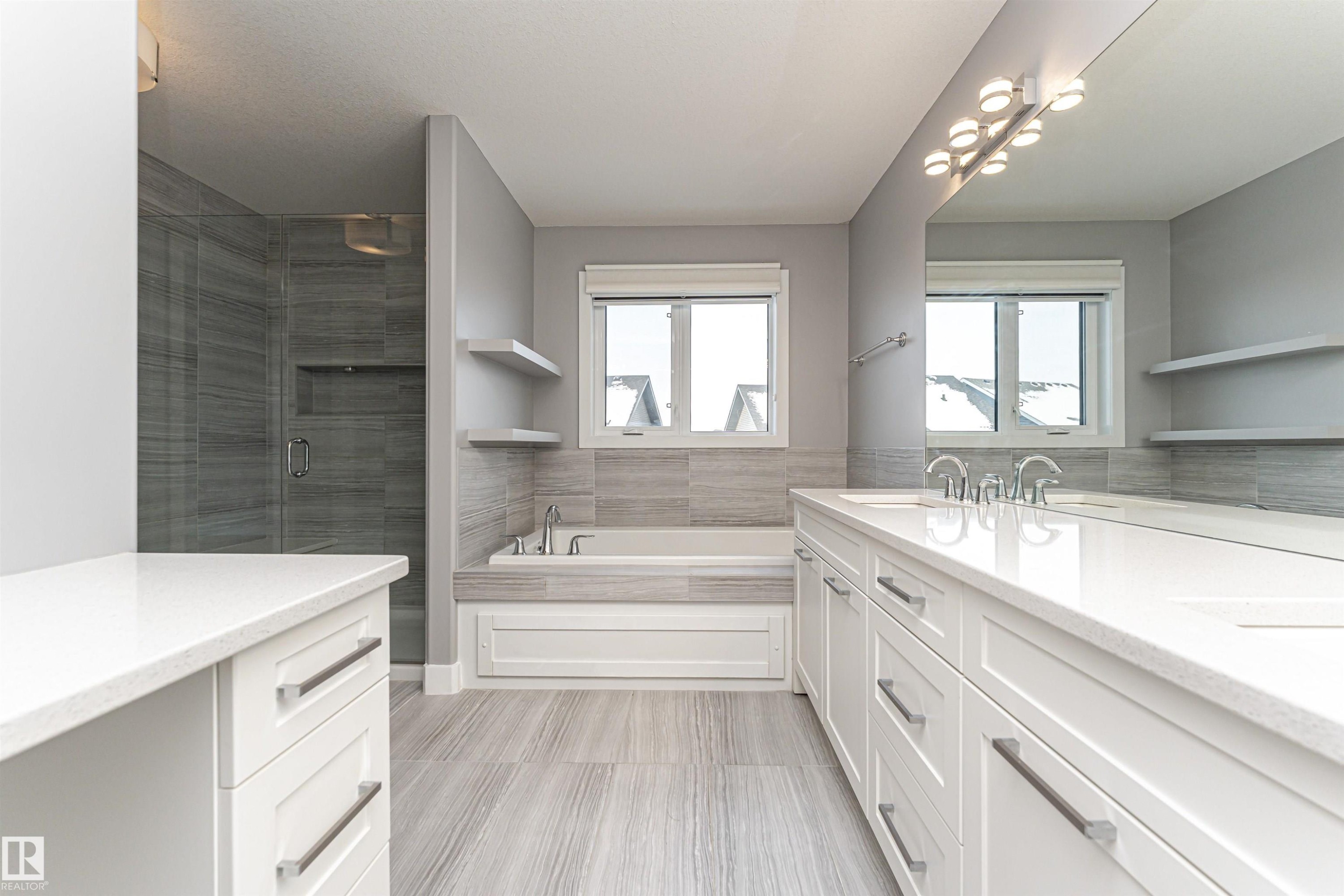 Full bathroom with a garden tub, double vanity, a shower stall, and healthy amount of natural light - 3611 Keswick Boulevard, Edmonton, AB - Indoor Photo Showing Bathroom