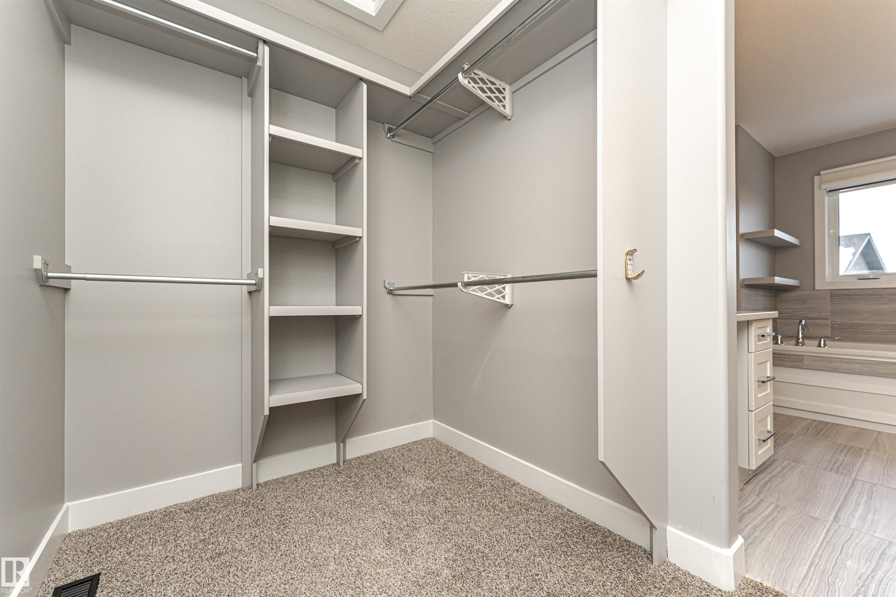 Walk in closet with light colored carpet - 3611 Keswick Boulevard, Edmonton, AB - Indoor With Storage