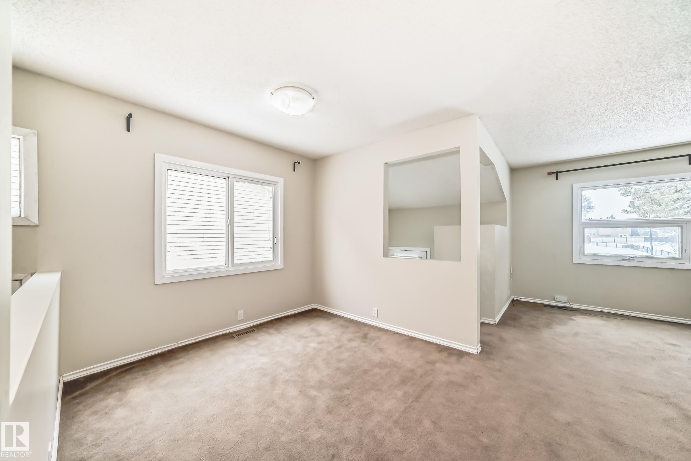 Carpeted empty room with baseboards - 5308 20 Avenue, Edmonton, AB - Indoor Photo Showing Other Room