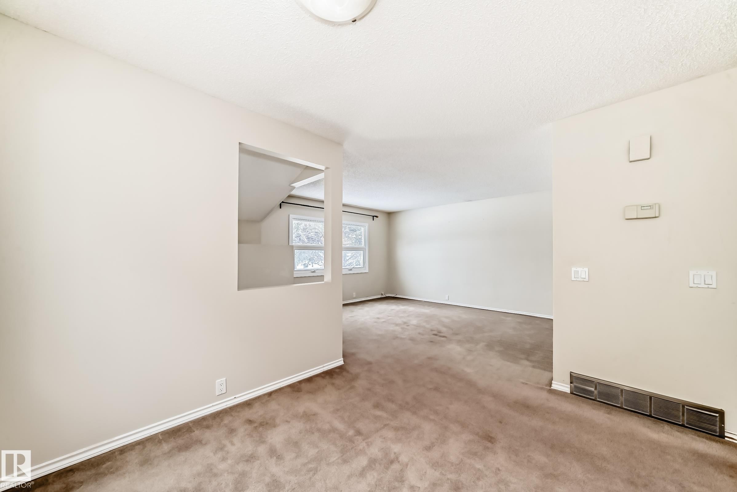 Spare room featuring carpet flooring and a textured ceiling - 5308 20 Avenue, Edmonton, AB - Indoor Photo Showing Other Room