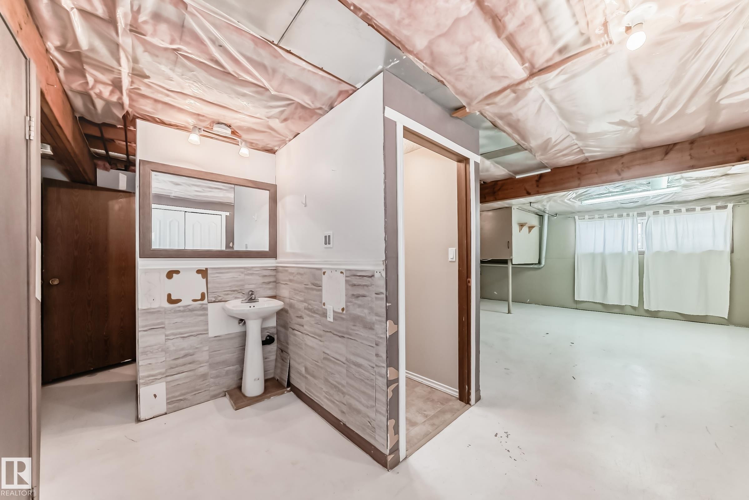 Bathroom featuring finished concrete flooring and a wainscoted wall - 5308 20 Avenue, Edmonton, AB - Indoor Photo Showing Basement