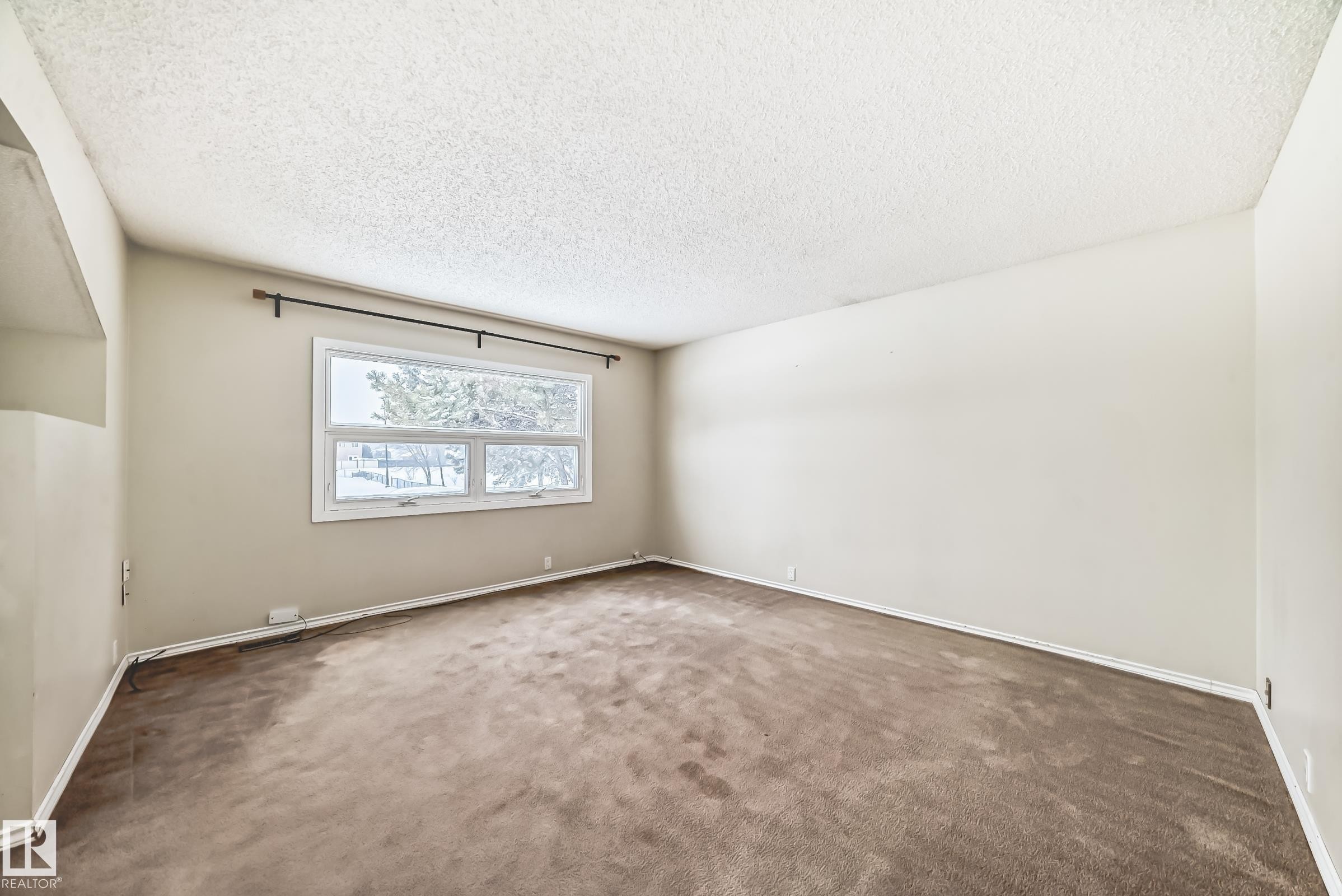 Unfurnished room featuring a textured ceiling and carpet floors - 5308 20 Avenue, Edmonton, AB - Indoor Photo Showing Other Room