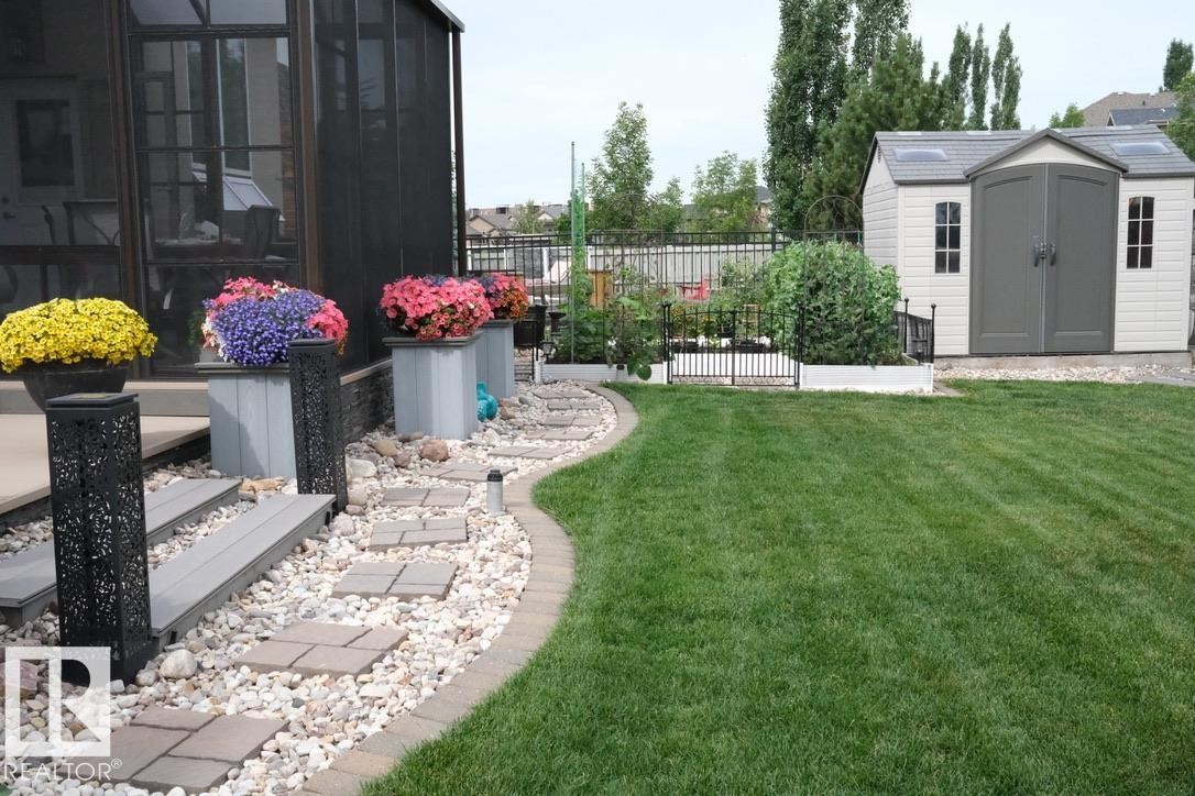 View of yard with a storage shed, a sunroom, and a garden - 169 Callaghan Drive, Edmonton, AB - Outdoor With Deck Patio Veranda