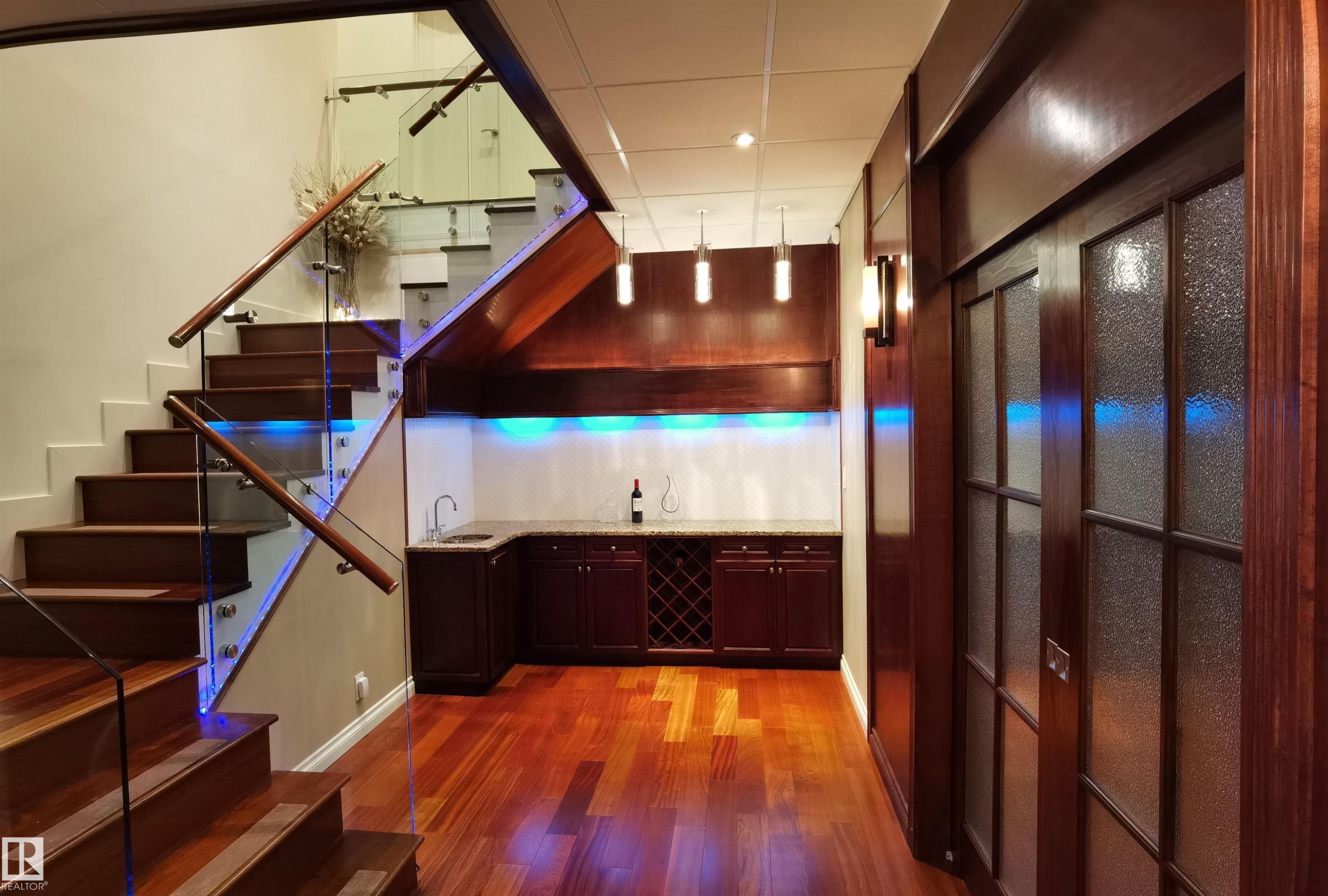 Kitchen featuring light wood finished floors, paneled built in refrigerator, a kitchen island, and pendant lighting - 169 Callaghan Drive, Edmonton, AB - Indoor