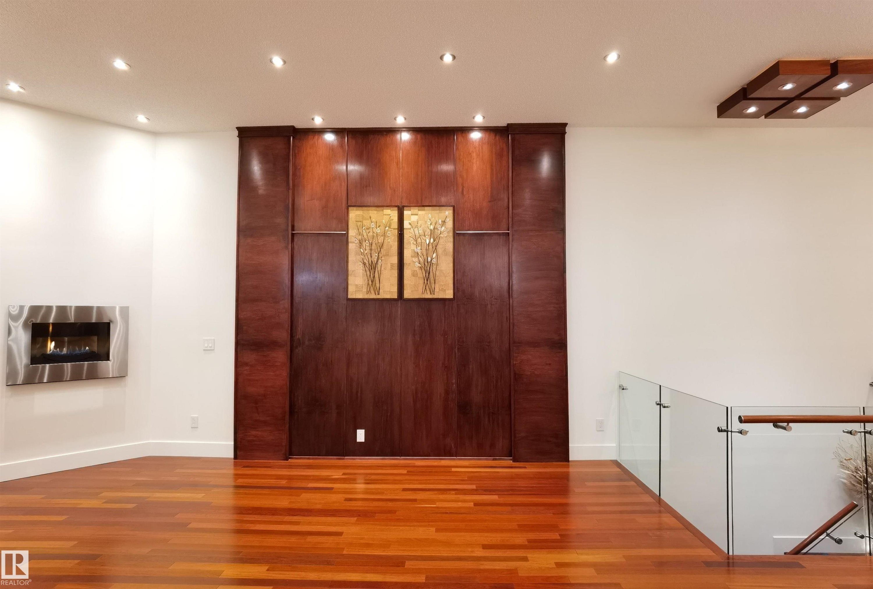Detailed view of recessed lighting, wood finished floors, and a glass covered fireplace - 169 Callaghan Drive, Edmonton, AB - Indoor Photo Showing Other Room