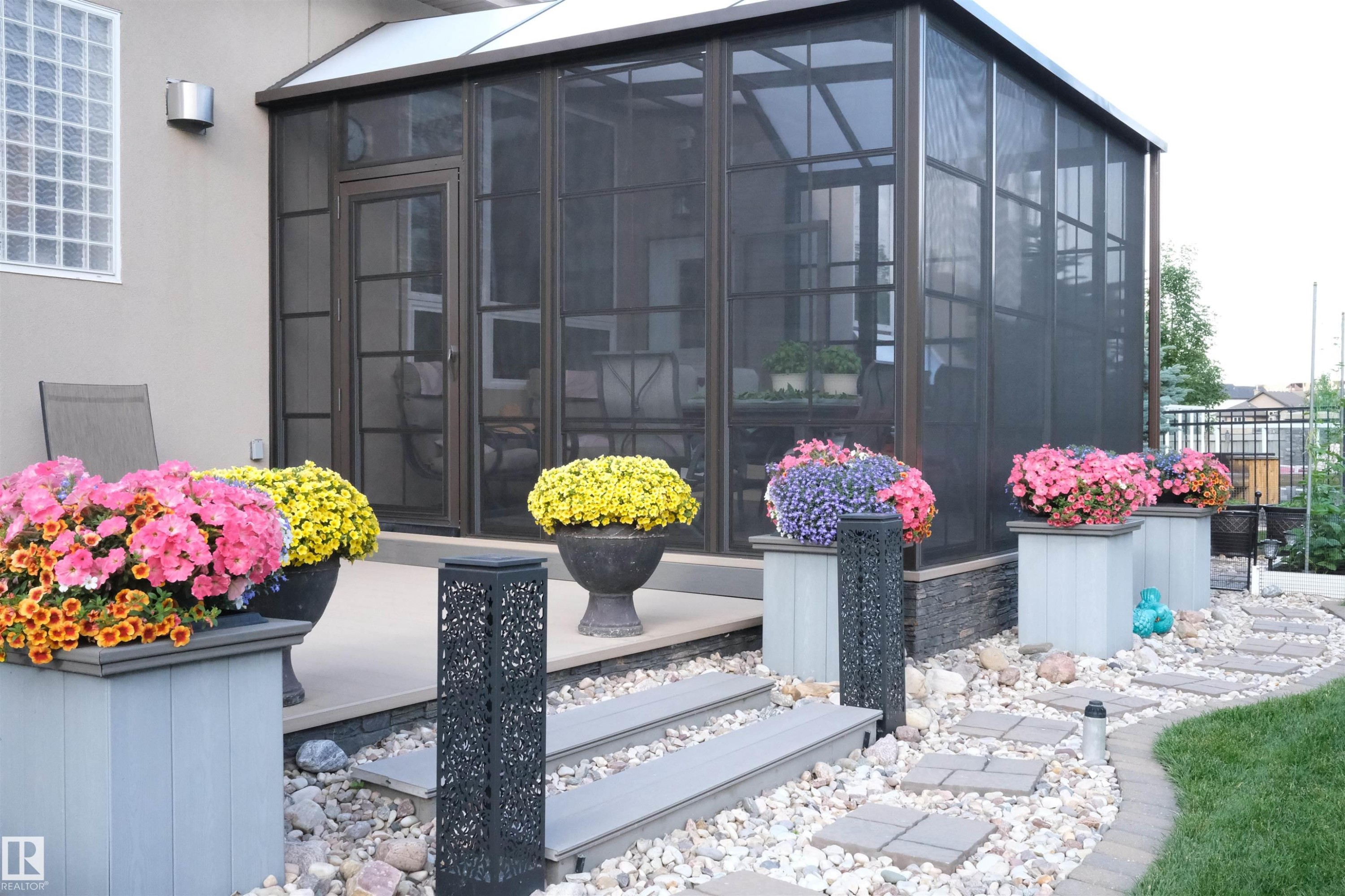 View of exterior entry with a sunroom and stone siding - 169 Callaghan Drive, Edmonton, AB - Outdoor With Deck Patio Veranda