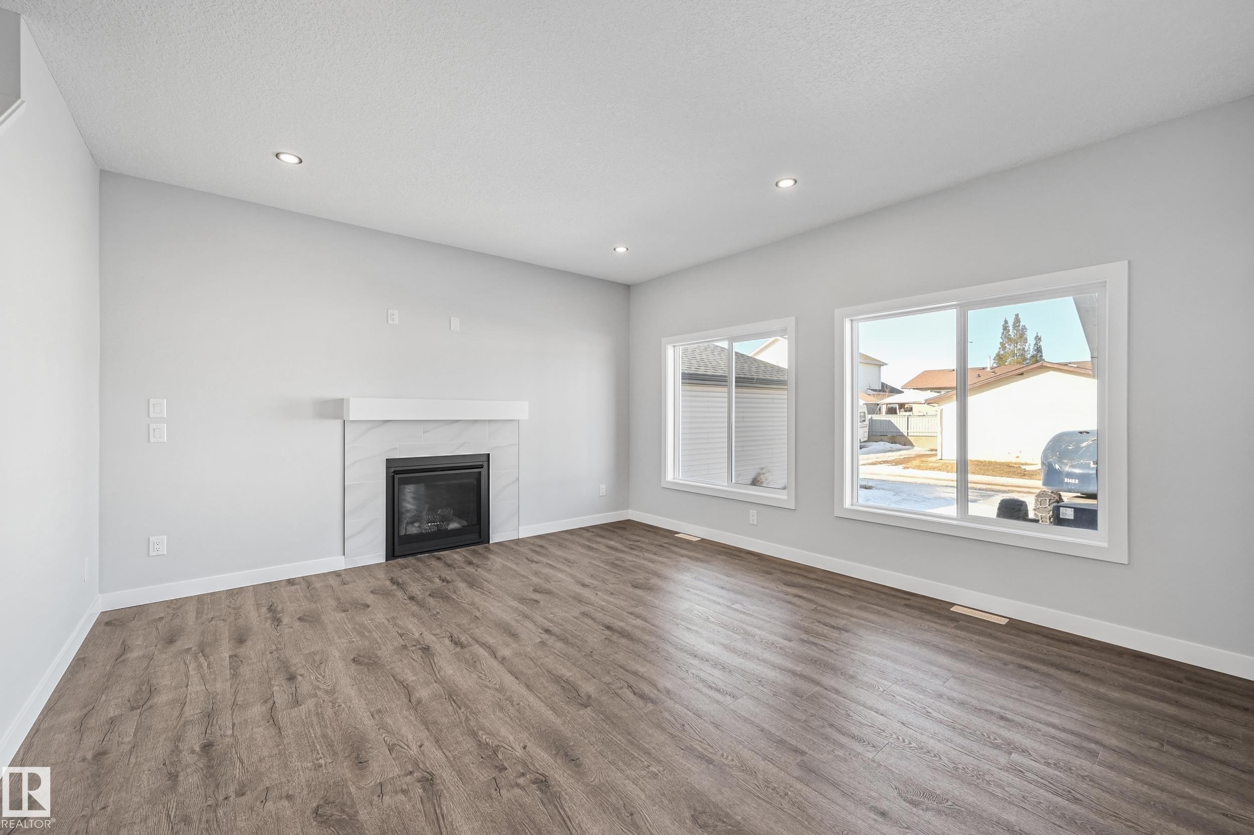 76 Maple Crescent, Gibbons, AB - Indoor Photo Showing Living Room With Fireplace