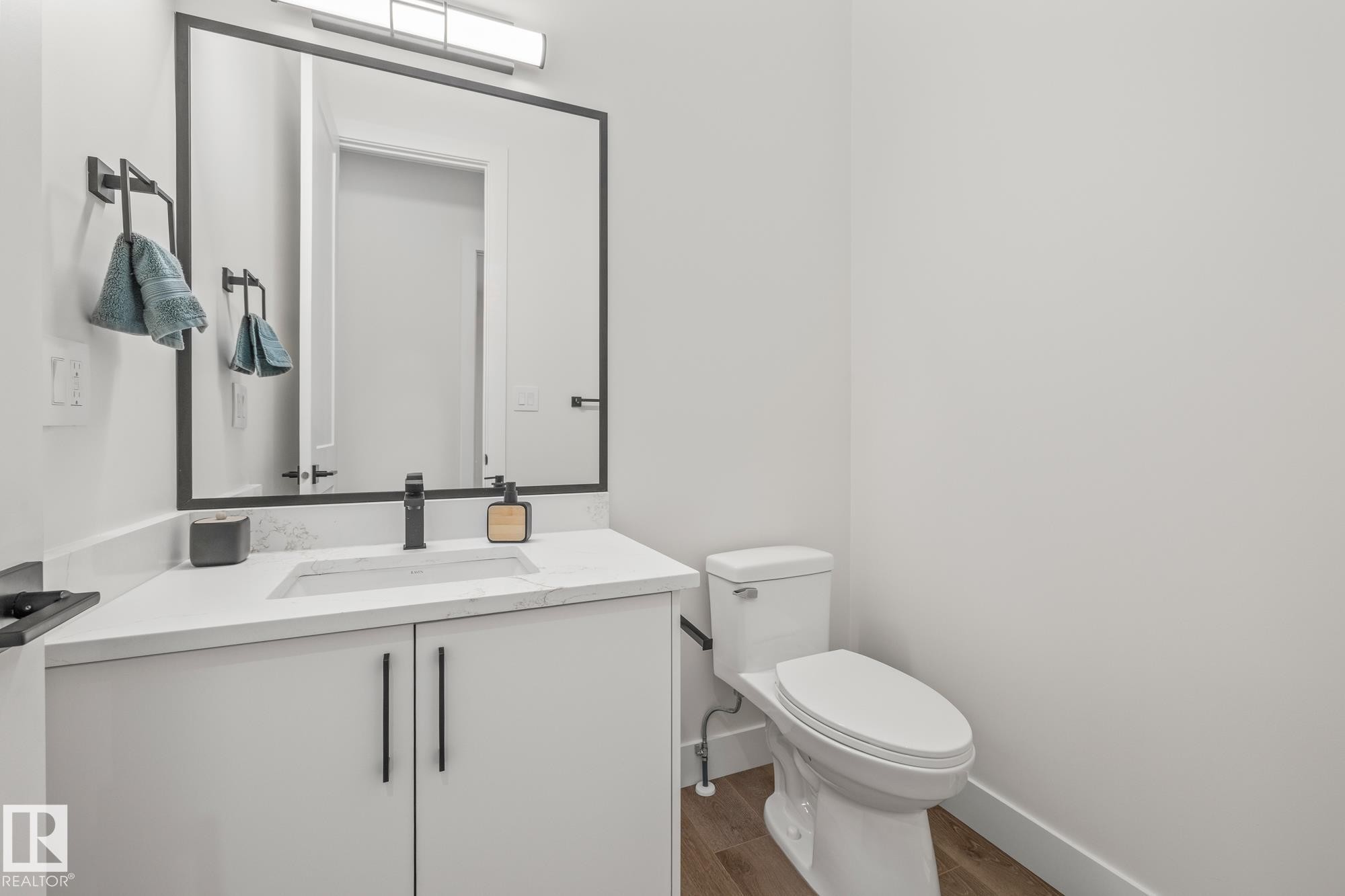 Bathroom with vanity and dark wood-style floors - 132 Edgewater Circle, Leduc, AB - Indoor Photo Showing Bathroom