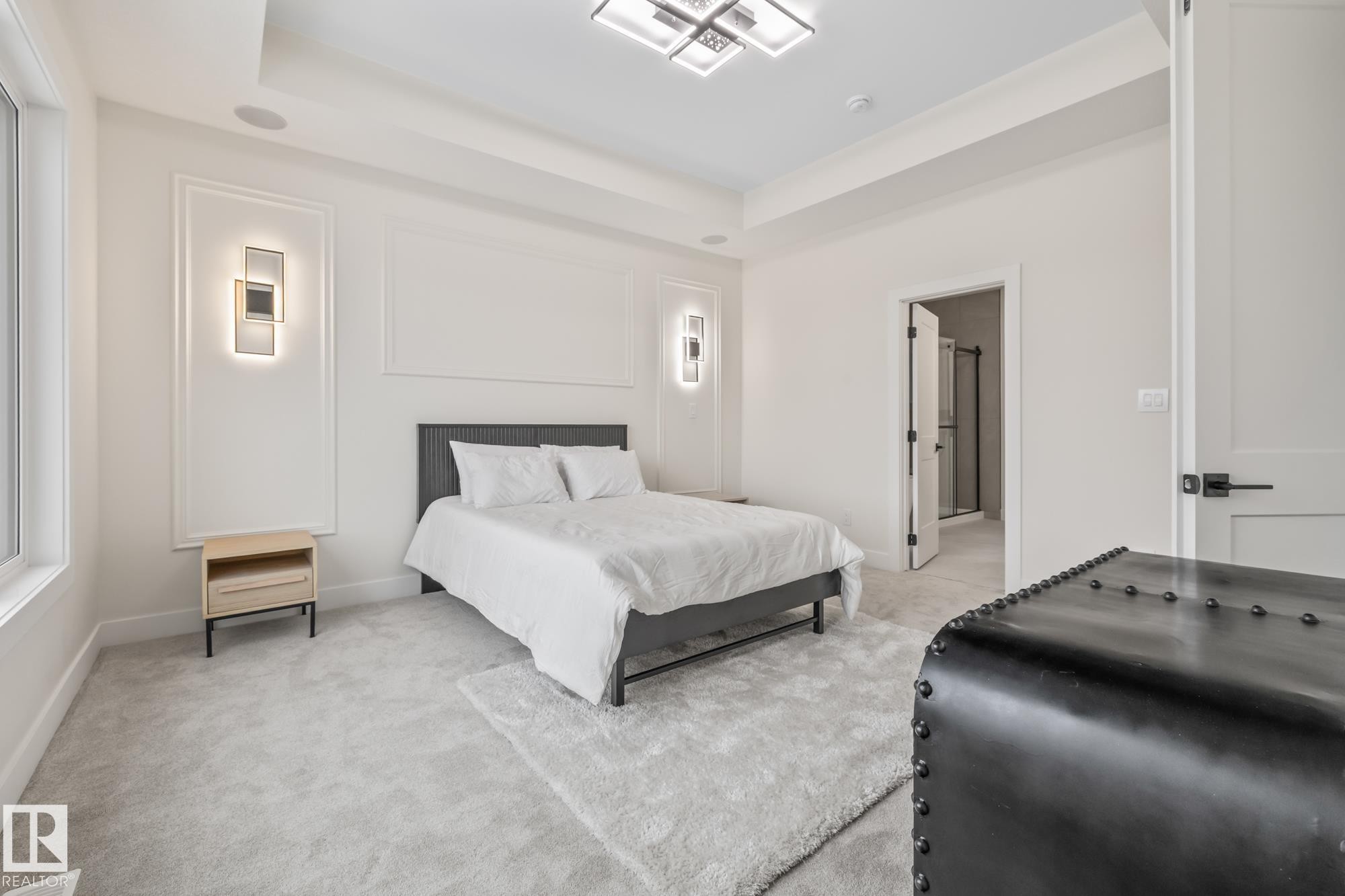 Bedroom with a tray ceiling, light carpet, and ensuite bath - 132 Edgewater Circle, Leduc, AB - Indoor Photo Showing Bedroom