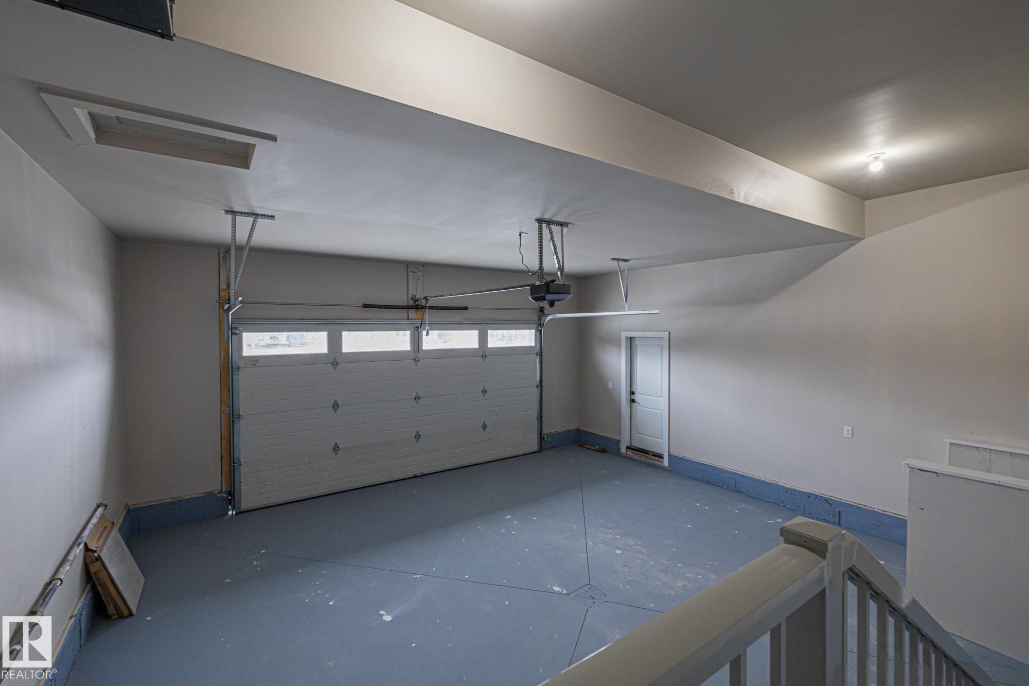 Garage featuring baseboards - 132 Edgewater Circle, Leduc, AB - Indoor Photo Showing Garage