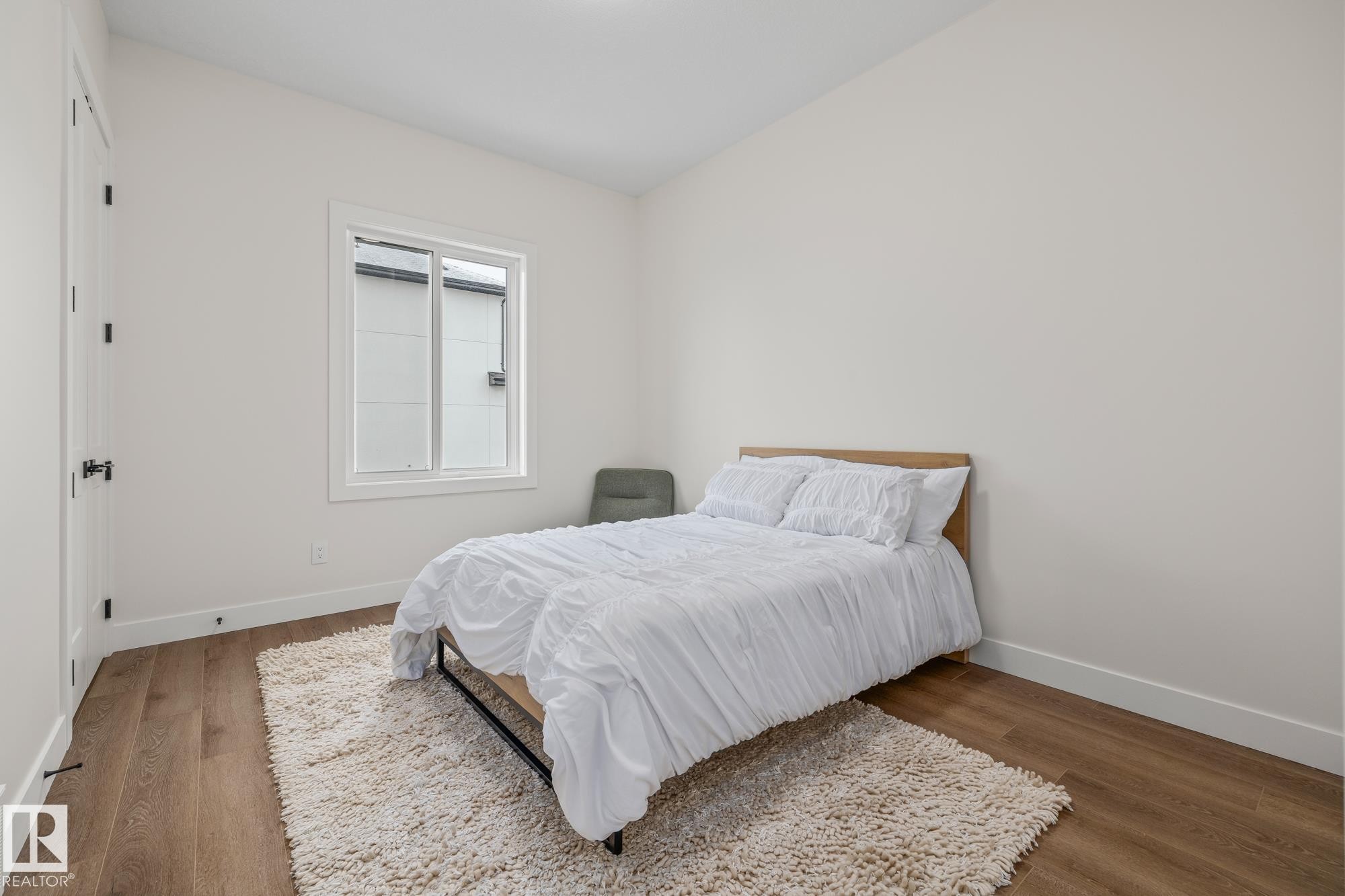 Bedroom with baseboards and wood finished floors - 132 Edgewater Circle, Leduc, AB - Indoor Photo Showing Bedroom