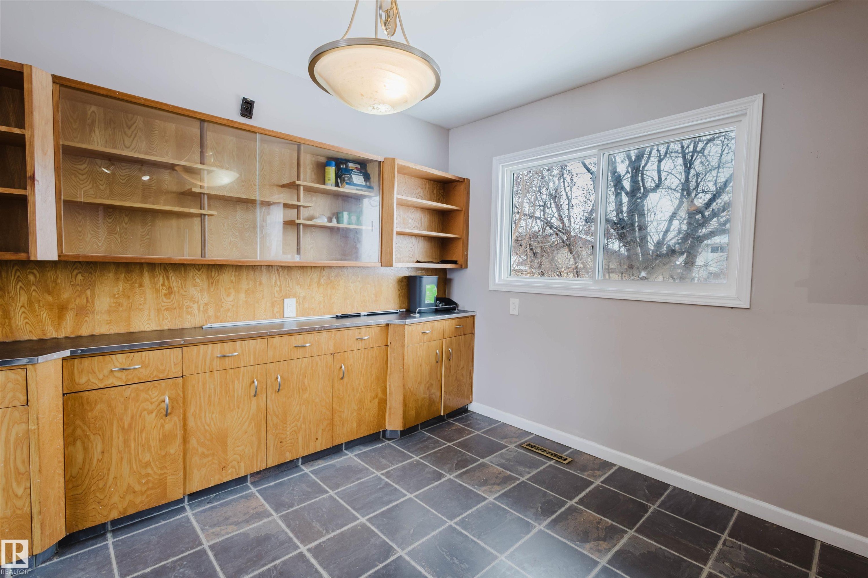Kitchen with stainless steel counters, open shelves, and pendant lighting - 6048 105B Street Nw, Edmonton, AB - Indoor Photo Showing Other Room