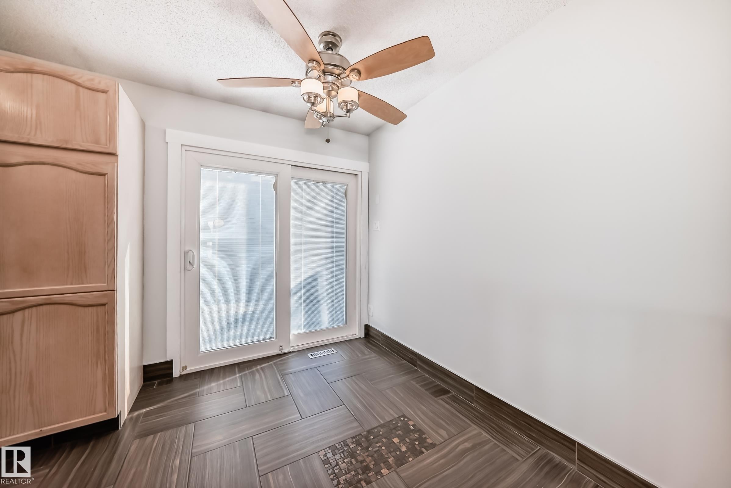 Entryway with ceiling fan, a textured ceiling, and parquet floors - 7011 190B Street, Edmonton, AB - Indoor Photo Showing Other Room