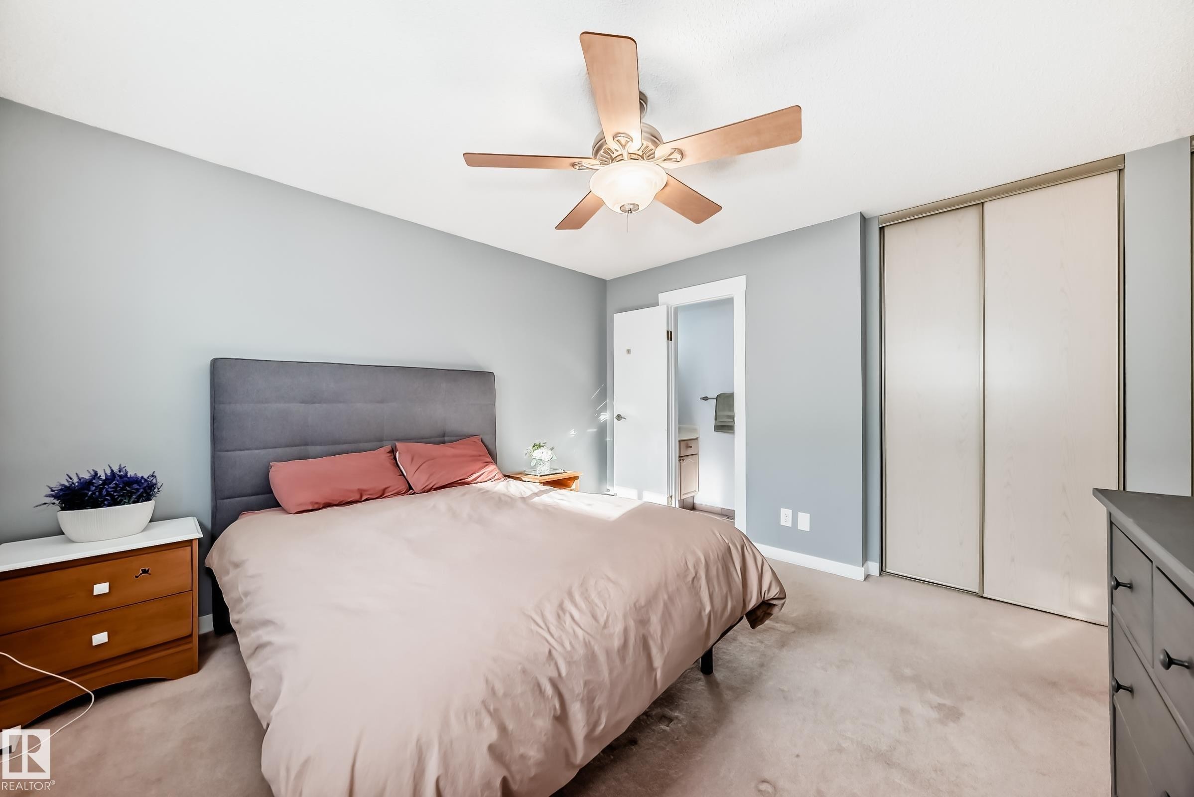Bedroom with light carpet, a ceiling fan, ensuite bath, and a closet - 7011 190B Street, Edmonton, AB - Indoor Photo Showing Bedroom
