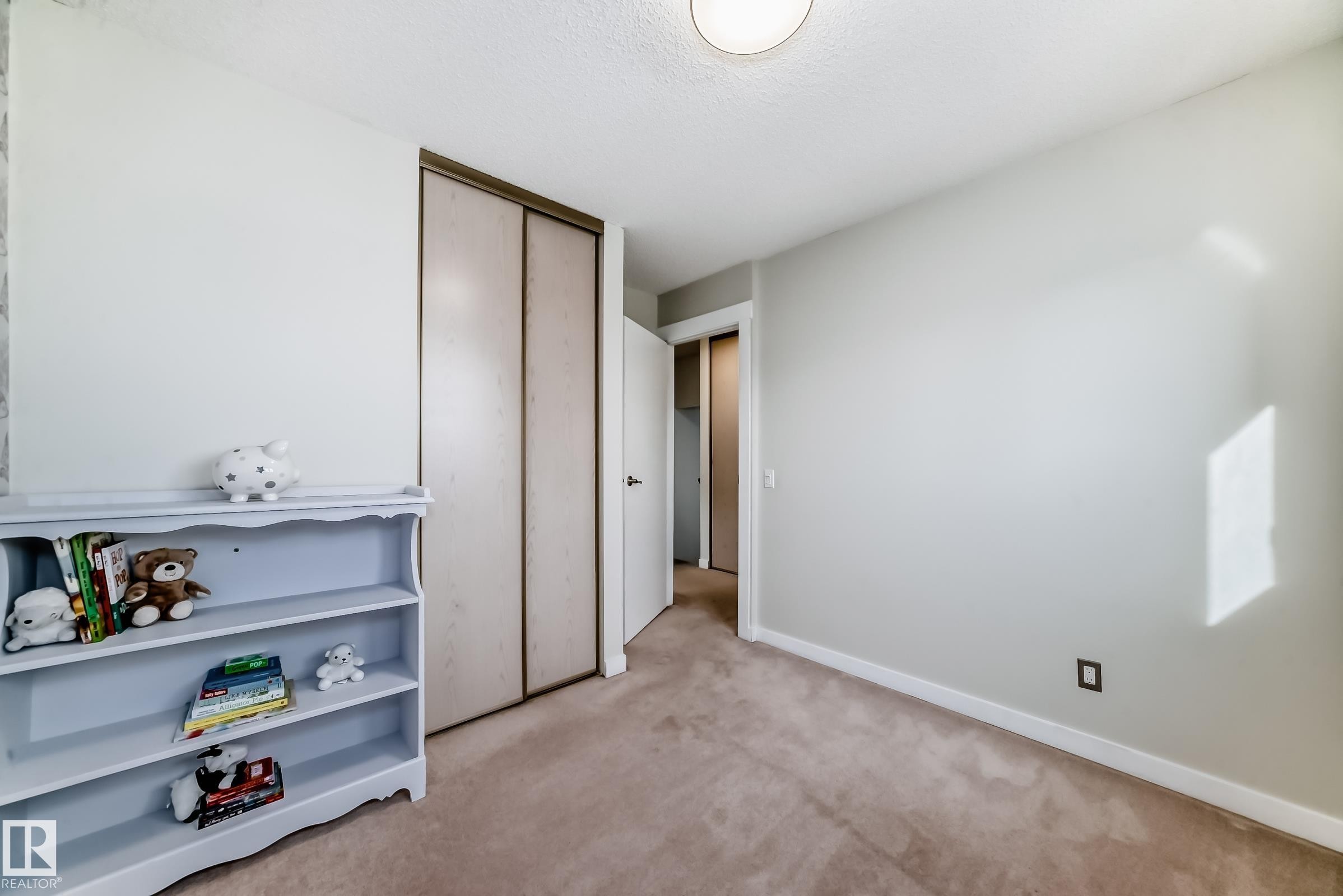Unfurnished bedroom featuring light carpet and a closet - 7011 190B Street, Edmonton, AB - Indoor Photo Showing Other Room