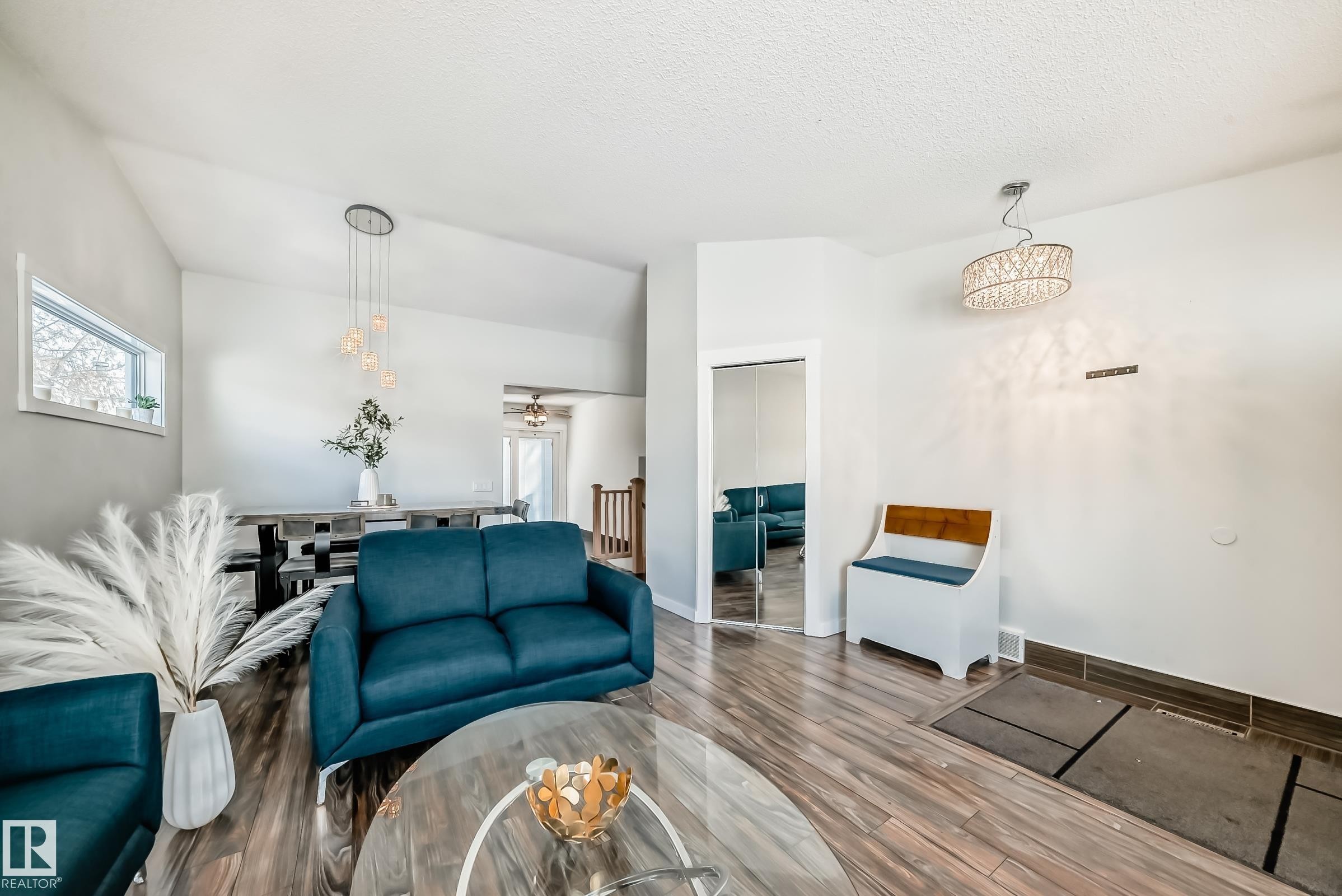 Living area with wood finished floors, ceiling fan, and a textured ceiling - 7011 190B Street, Edmonton, AB - Indoor Photo Showing Living Room