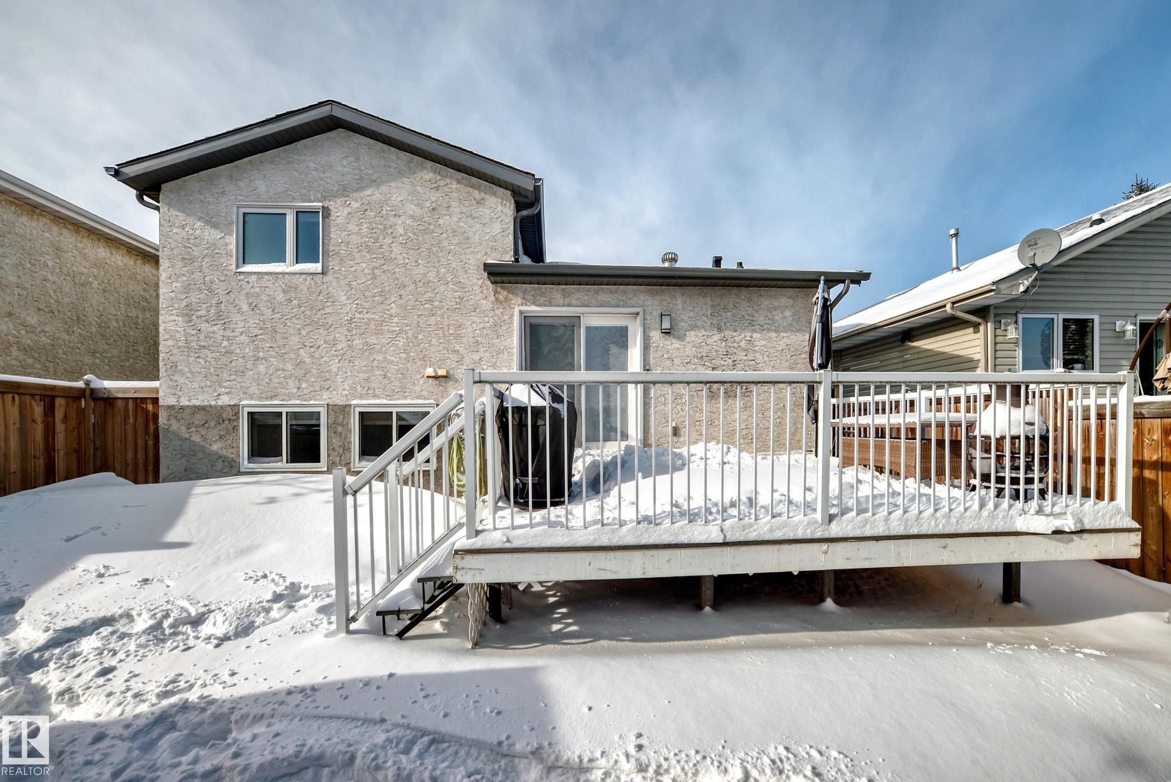Rear view of property with a deck and stucco siding - 7011 190B Street, Edmonton, AB - Outdoor With Deck Patio Veranda With Exterior