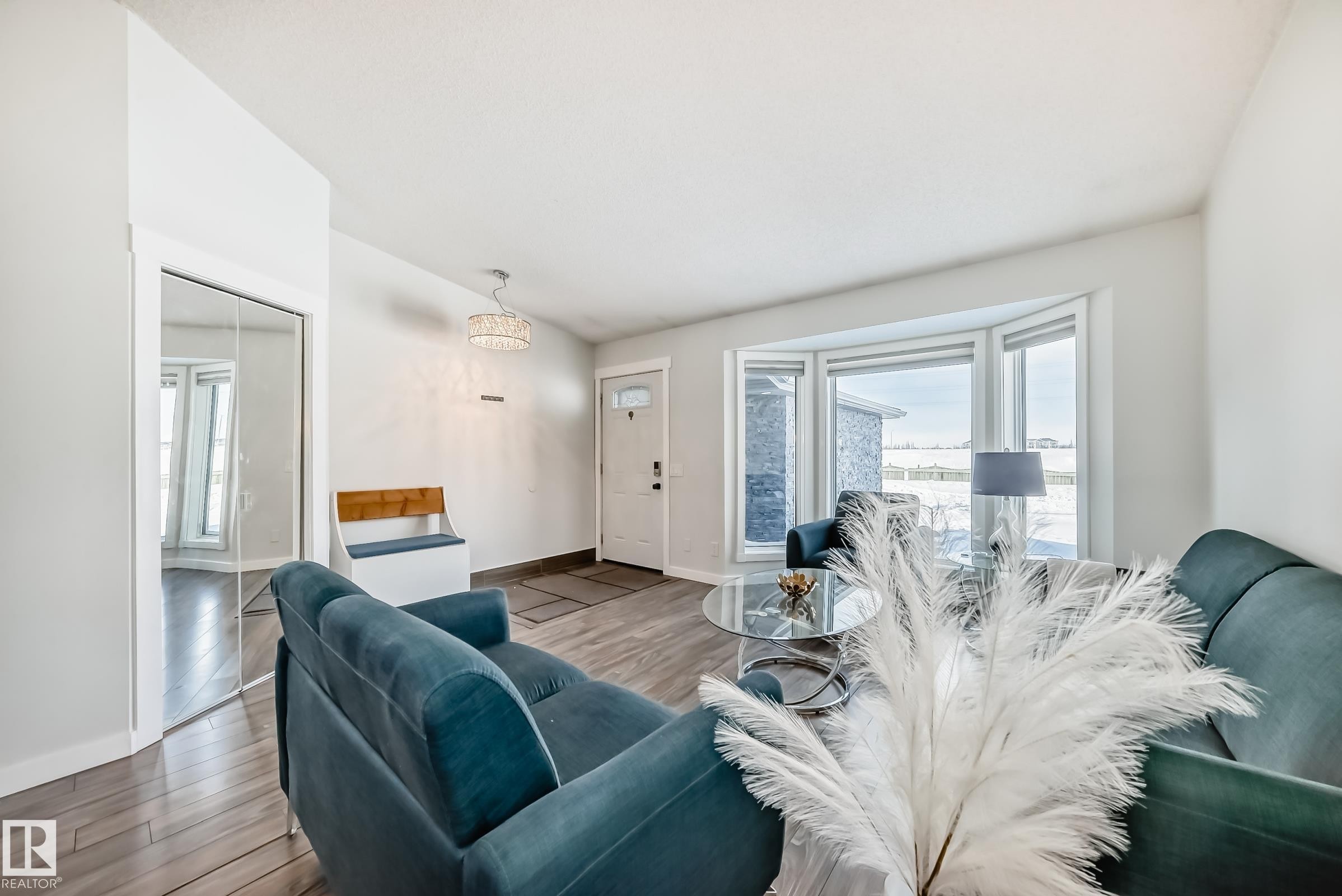 Living area with wood finished floors and vaulted ceiling - 7011 190B Street, Edmonton, AB - Indoor Photo Showing Living Room