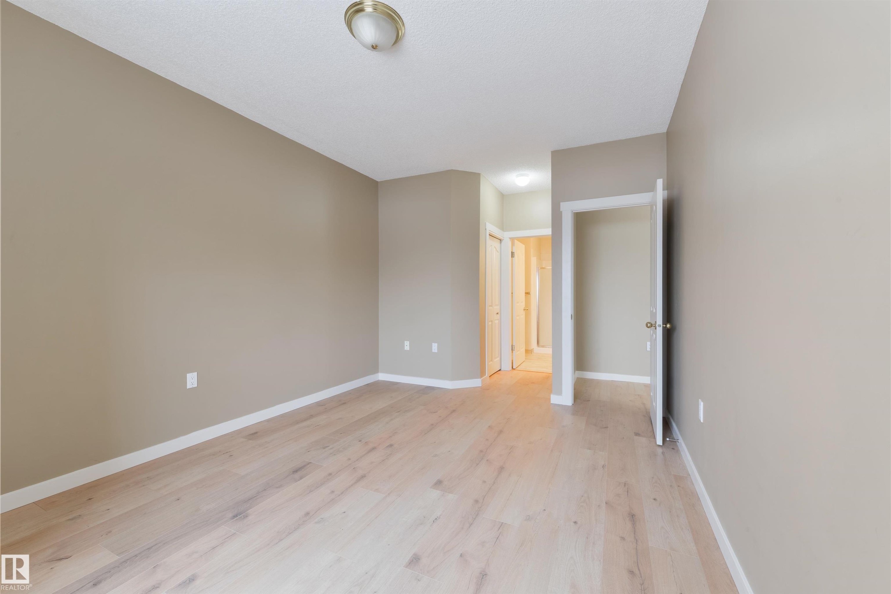 Spare room with baseboards and light wood-type flooring - 232 15499 Castle Downs Road, Edmonton, AB - Indoor Photo Showing Other Room