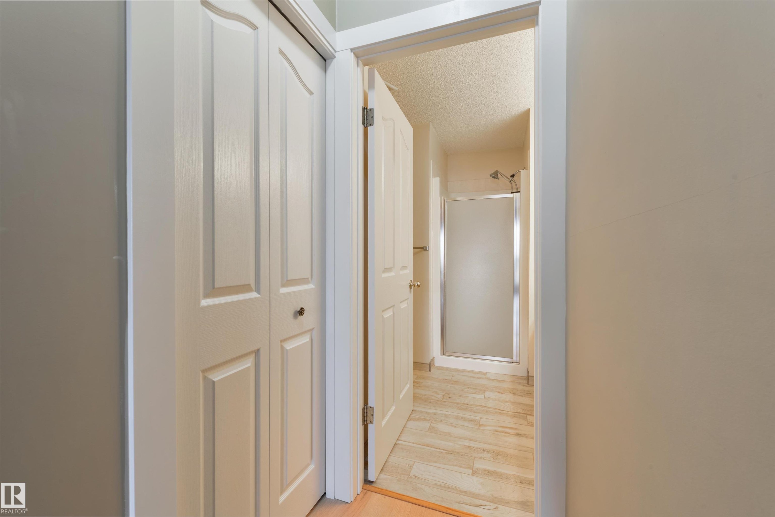 Corridor with a textured ceiling and light wood-type flooring - 232 15499 Castle Downs Road, Edmonton, AB - Indoor Photo Showing Other Room