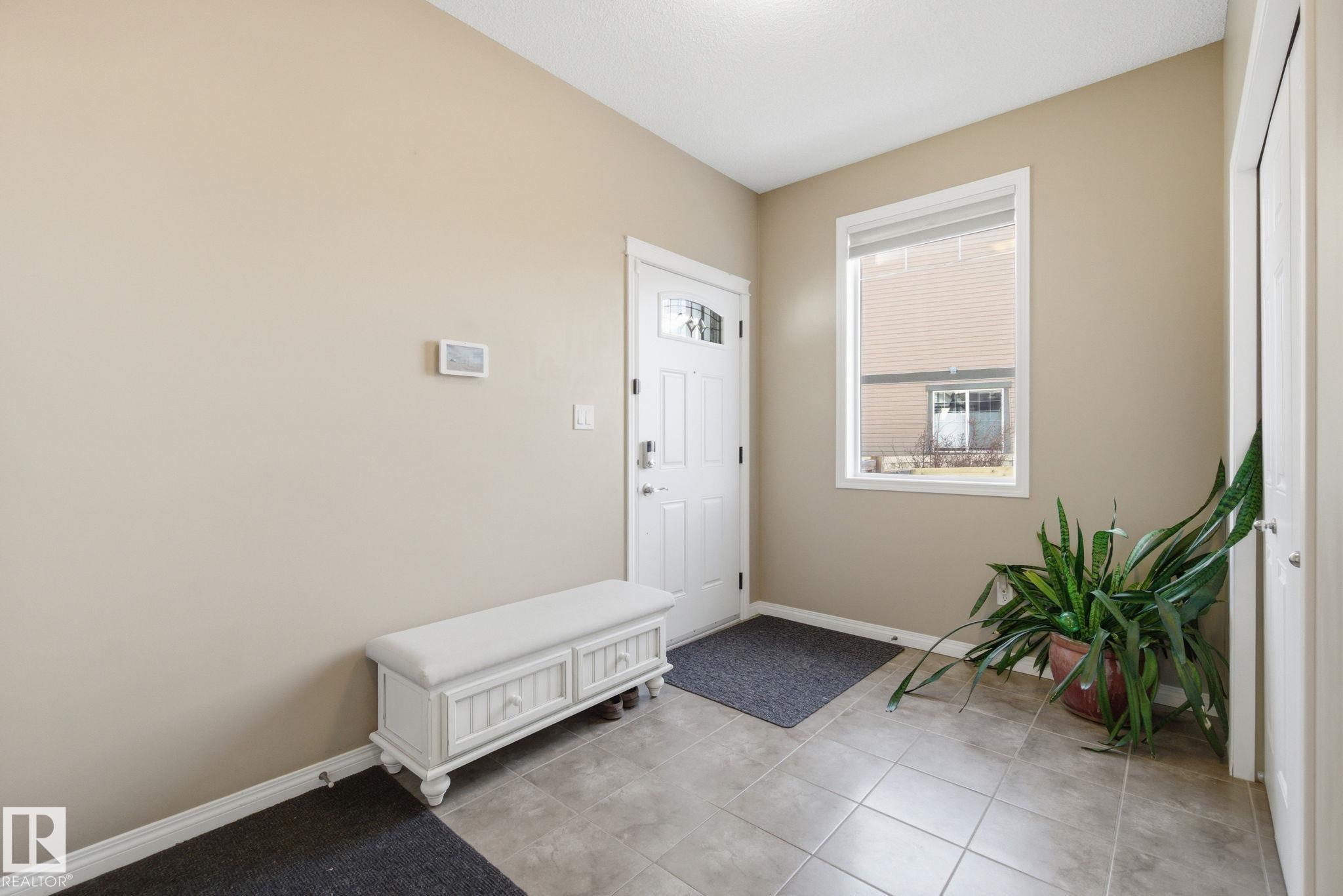 Entrance foyer featuring baseboards and light tile patterned floors - 3087 Arthurs Crescent, Edmonton, AB - Indoor Photo Showing Other Room