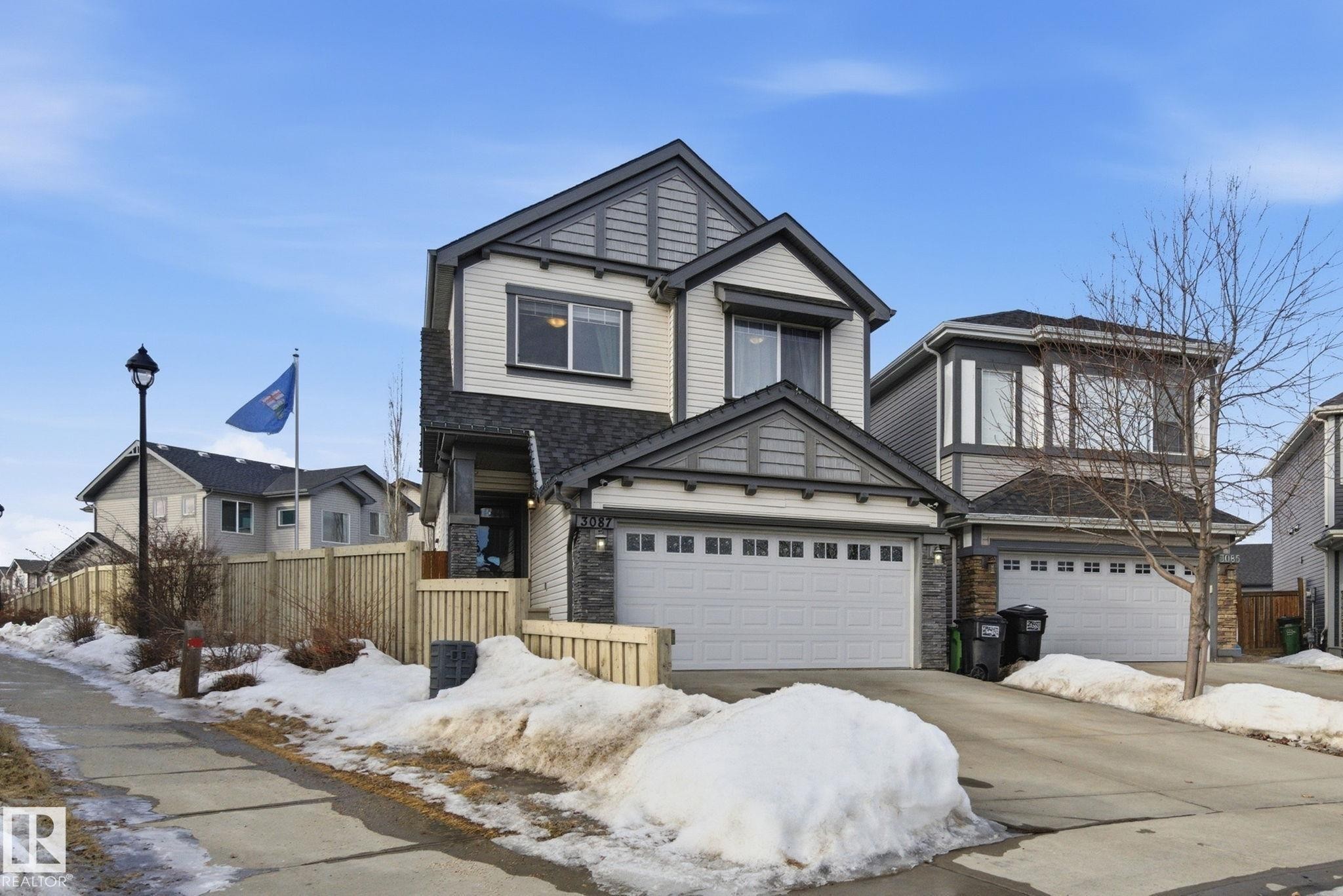 View of front of property with driveway and stone siding - 3087 Arthurs Crescent, Edmonton, AB - Outdoor With Facade