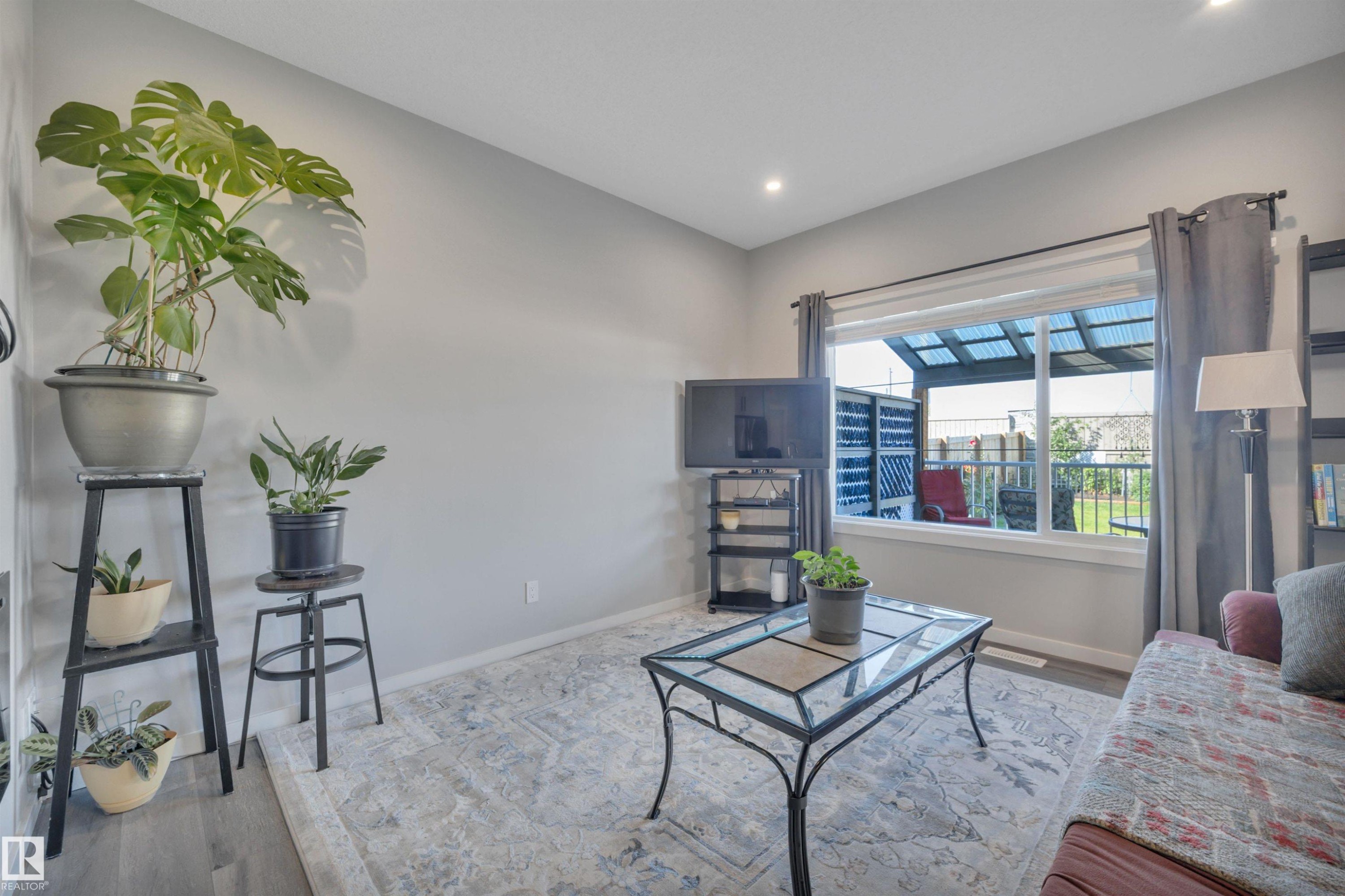 Living room featuring wood finished floors and recessed lighting - 157 Larch Crescent, Leduc, AB - Indoor Photo Showing Living Room