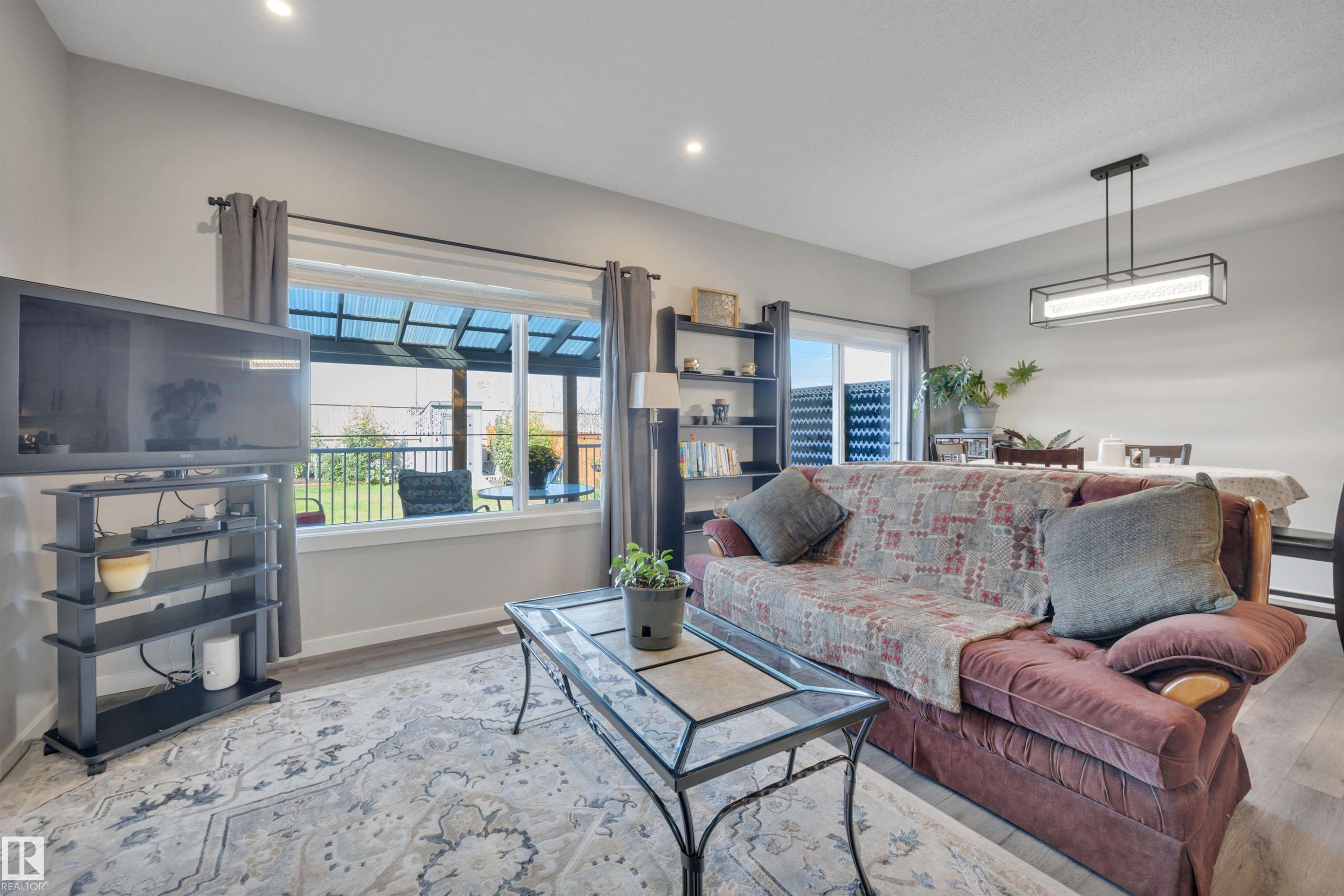 Living room featuring wood finished floors and recessed lighting - 157 Larch Crescent, Leduc, AB - Indoor Photo Showing Living Room