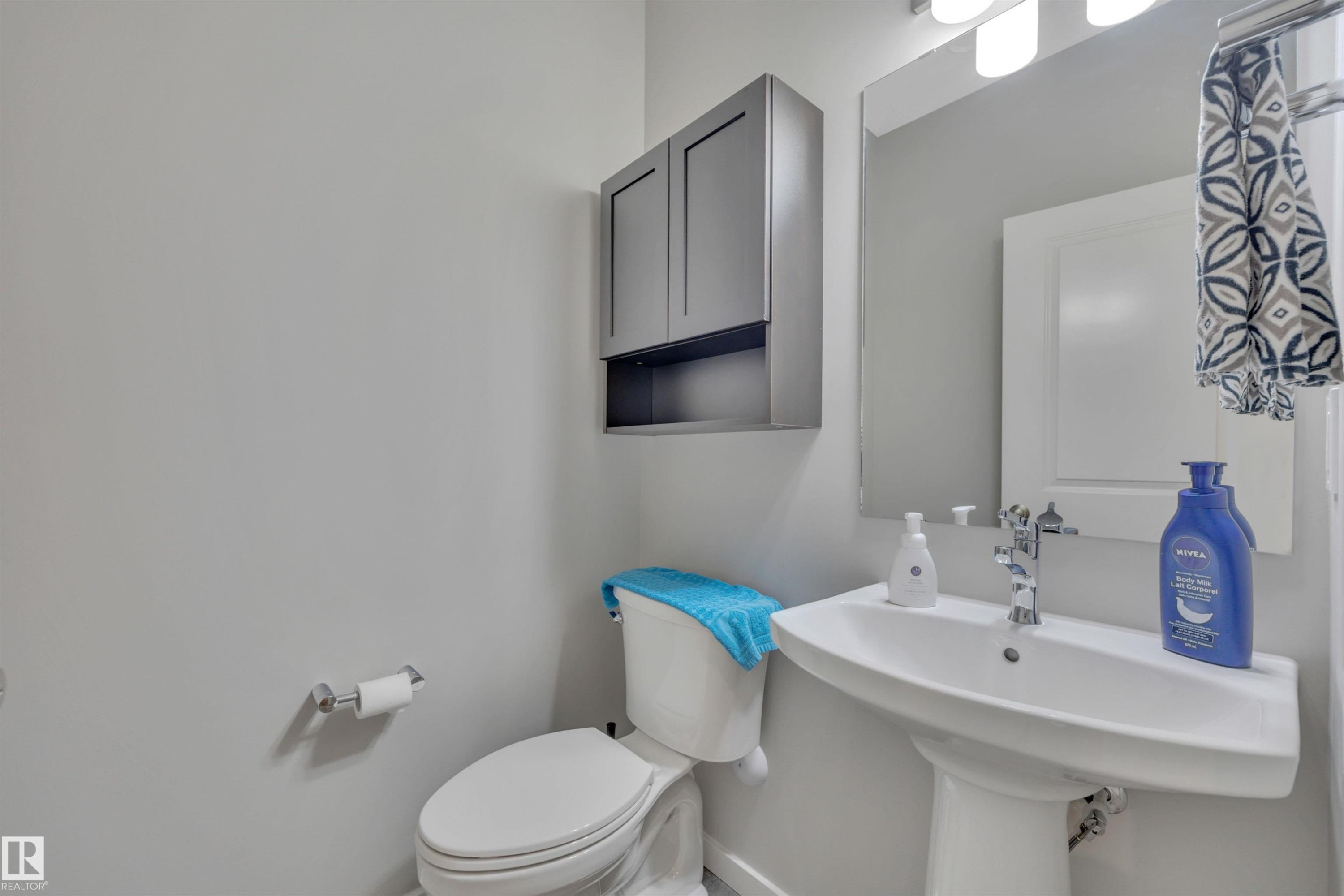 Half bathroom with toilet and a sink - 157 Larch Crescent, Leduc, AB - Indoor Photo Showing Bathroom