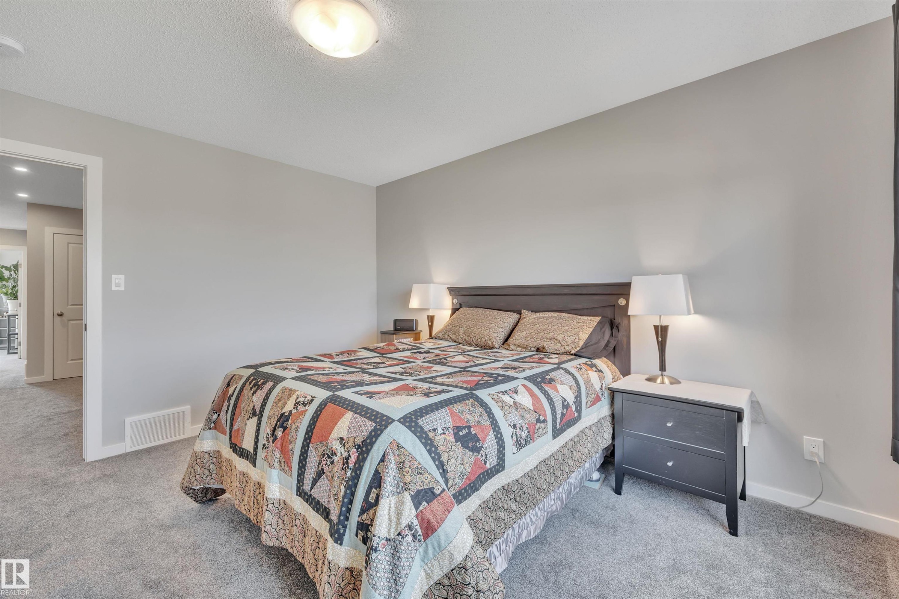 Bedroom featuring baseboards and light carpet - 157 Larch Crescent, Leduc, AB - Indoor Photo Showing Bedroom