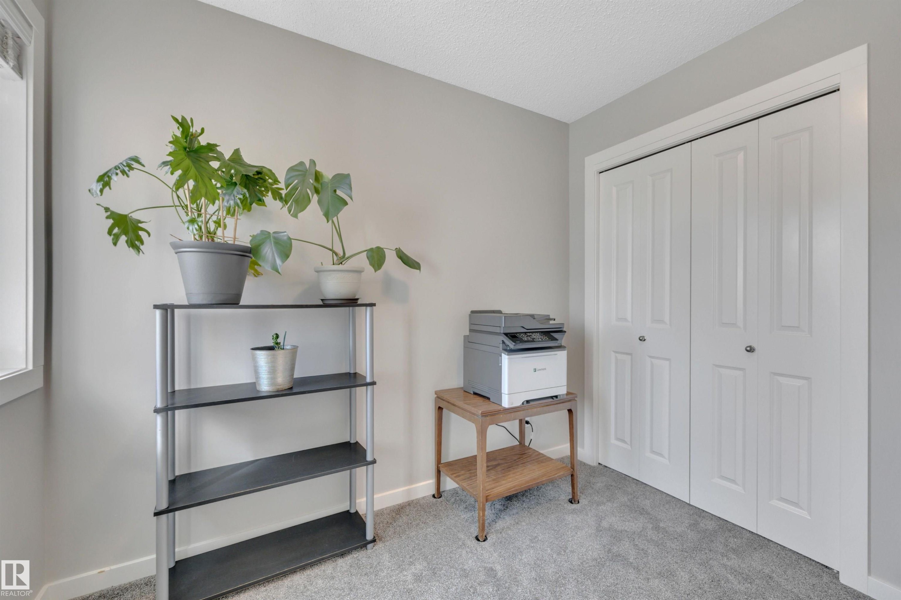 Office space with light carpet and a textured ceiling - 157 Larch Crescent, Leduc, AB - Indoor