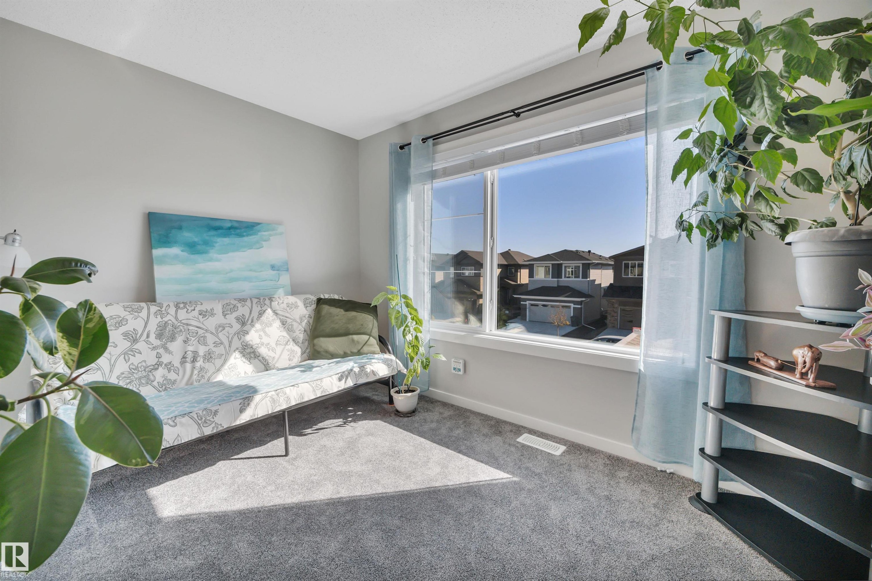 Living area featuring carpet floors and baseboards - 157 Larch Crescent, Leduc, AB - Indoor Photo Showing Bedroom
