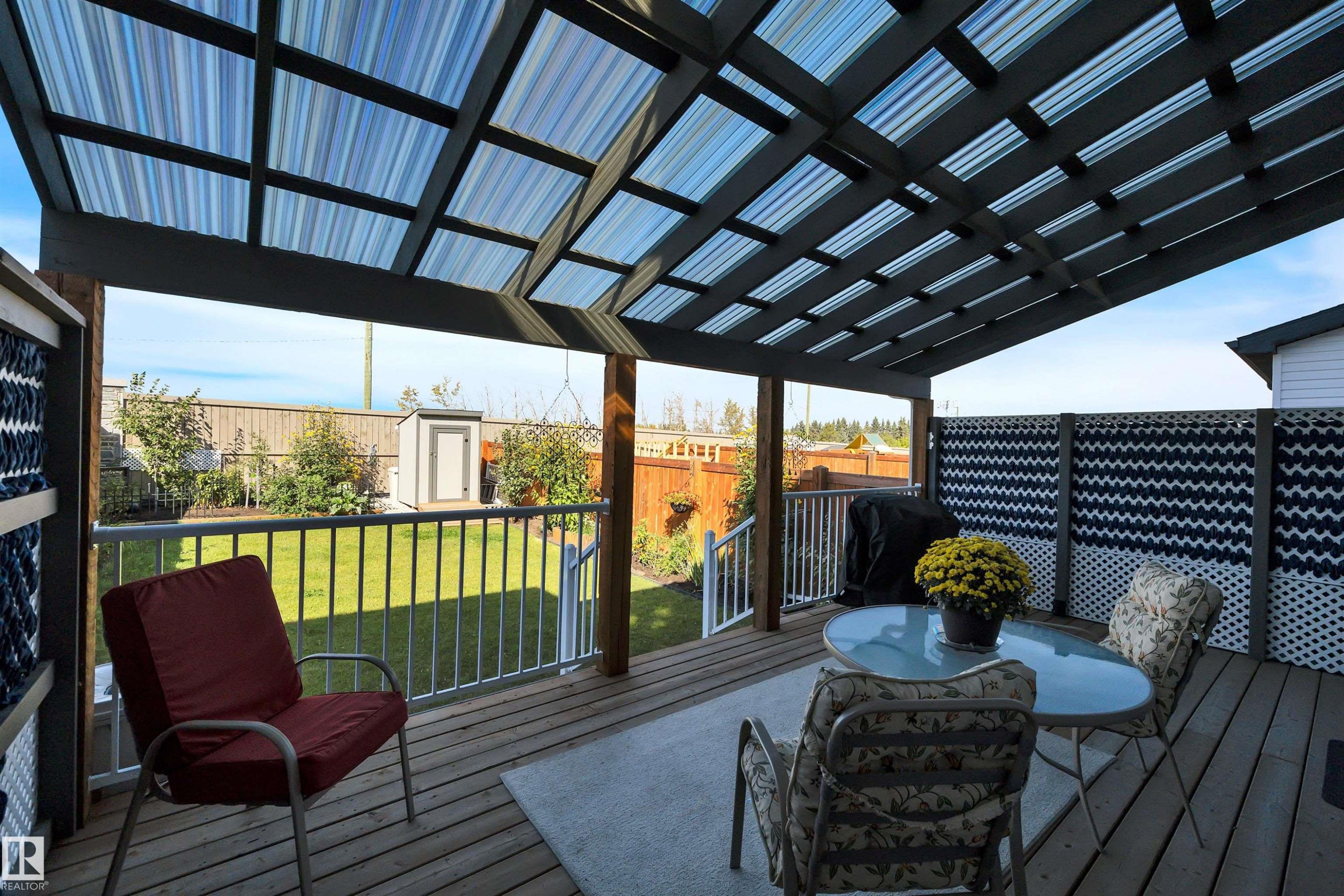 Wooden terrace featuring a shed, grilling area, outdoor dining area, and a fenced backyard - 157 Larch Crescent, Leduc, AB - Outdoor With Deck Patio Veranda With Exterior