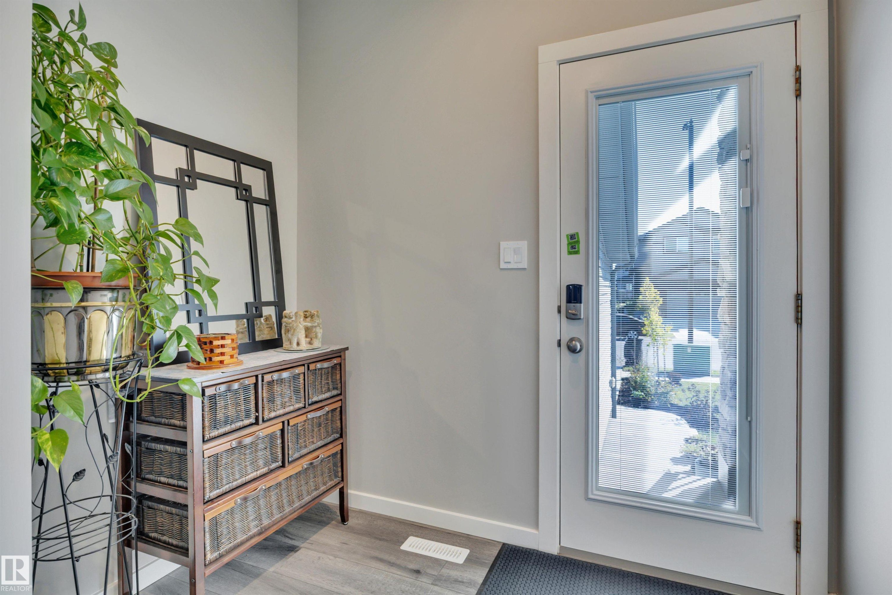 Entryway featuring healthy amount of natural light and wood finished floors - 157 Larch Crescent, Leduc, AB - Indoor Photo Showing Other Room
