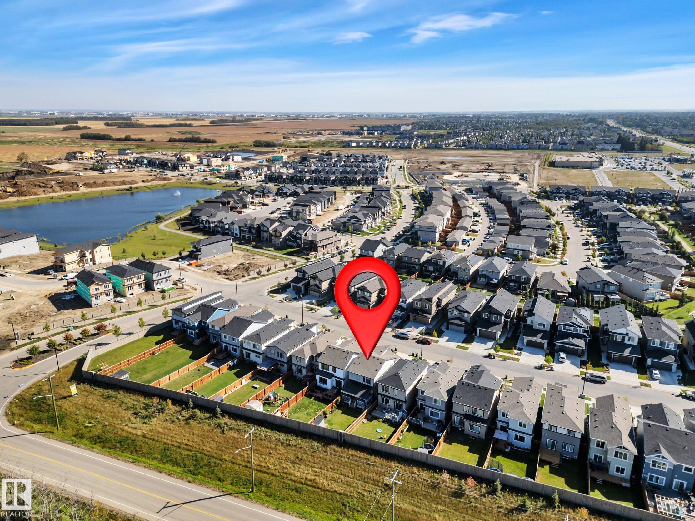 View of property location with nearby suburban area and a nearby body of water - 157 Larch Crescent, Leduc, AB - Outdoor With View