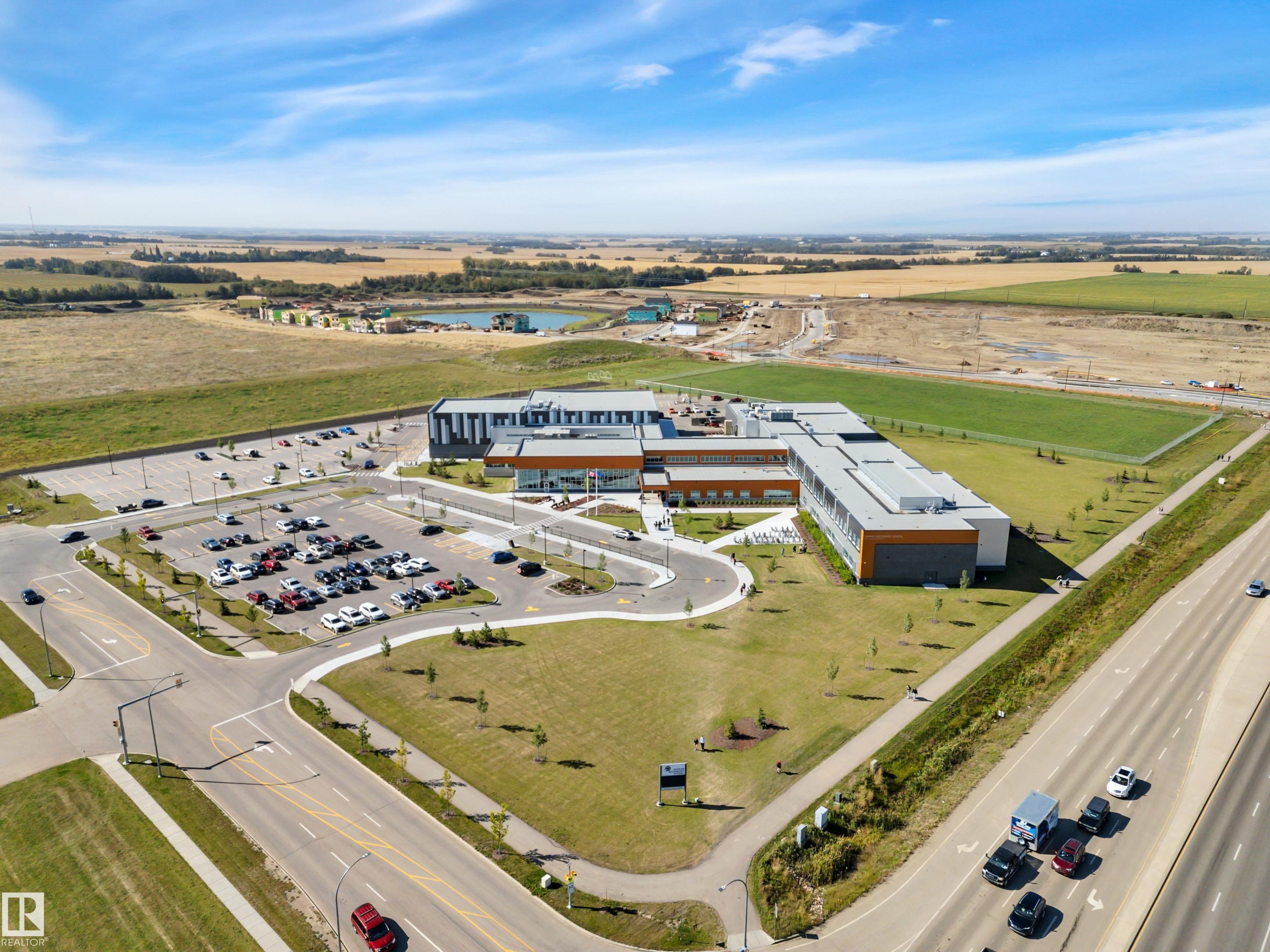 Drone / aerial view of a large body of water and a commercial area - 157 Larch Crescent, Leduc, AB - Outdoor With View