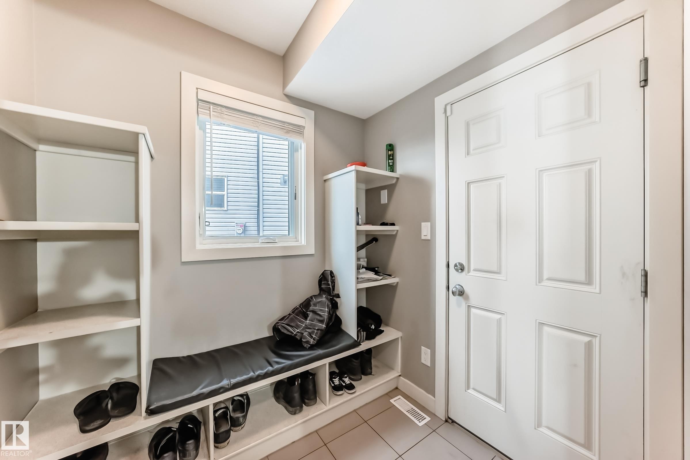 Mudroom with light tile patterned floors and baseboards - 1908 69 Street, Edmonton, AB - Indoor Photo Showing Other Room