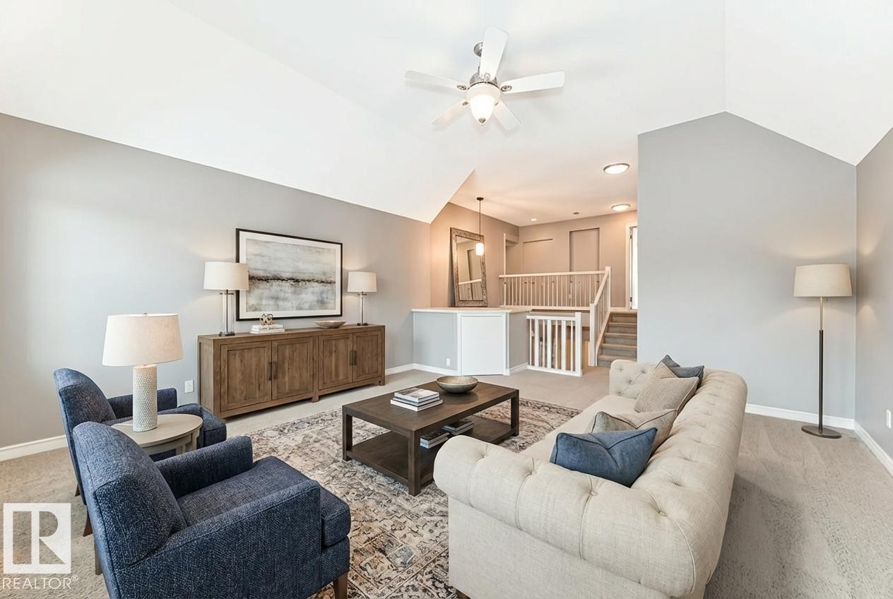 Carpeted living room featuring lofted ceiling and ceiling fan - 1908 69 Street, Edmonton, AB - Indoor Photo Showing Living Room