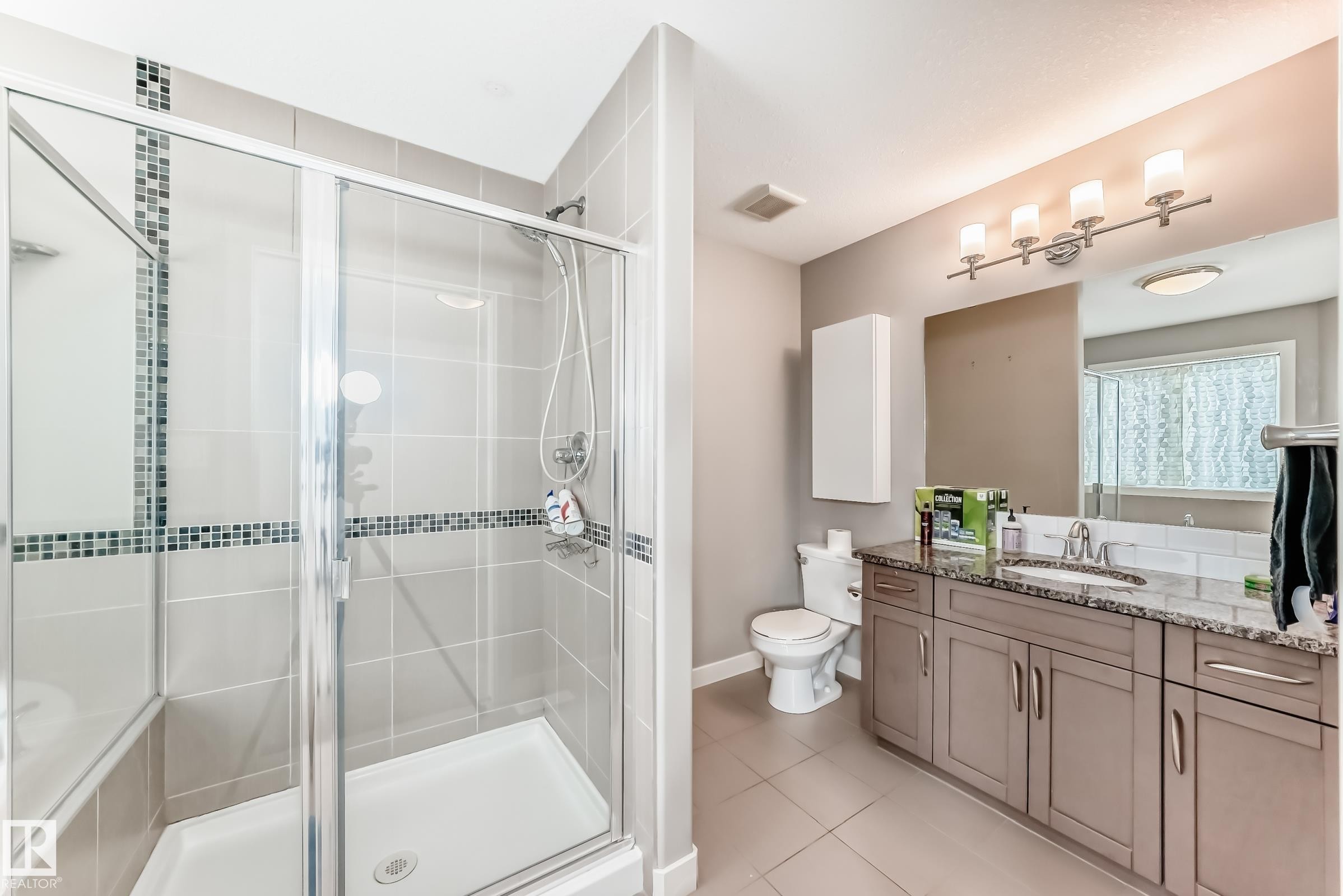 Full bath featuring vanity, a shower stall, and light tile patterned floors - 1908 69 Street, Edmonton, AB - Indoor Photo Showing Bathroom