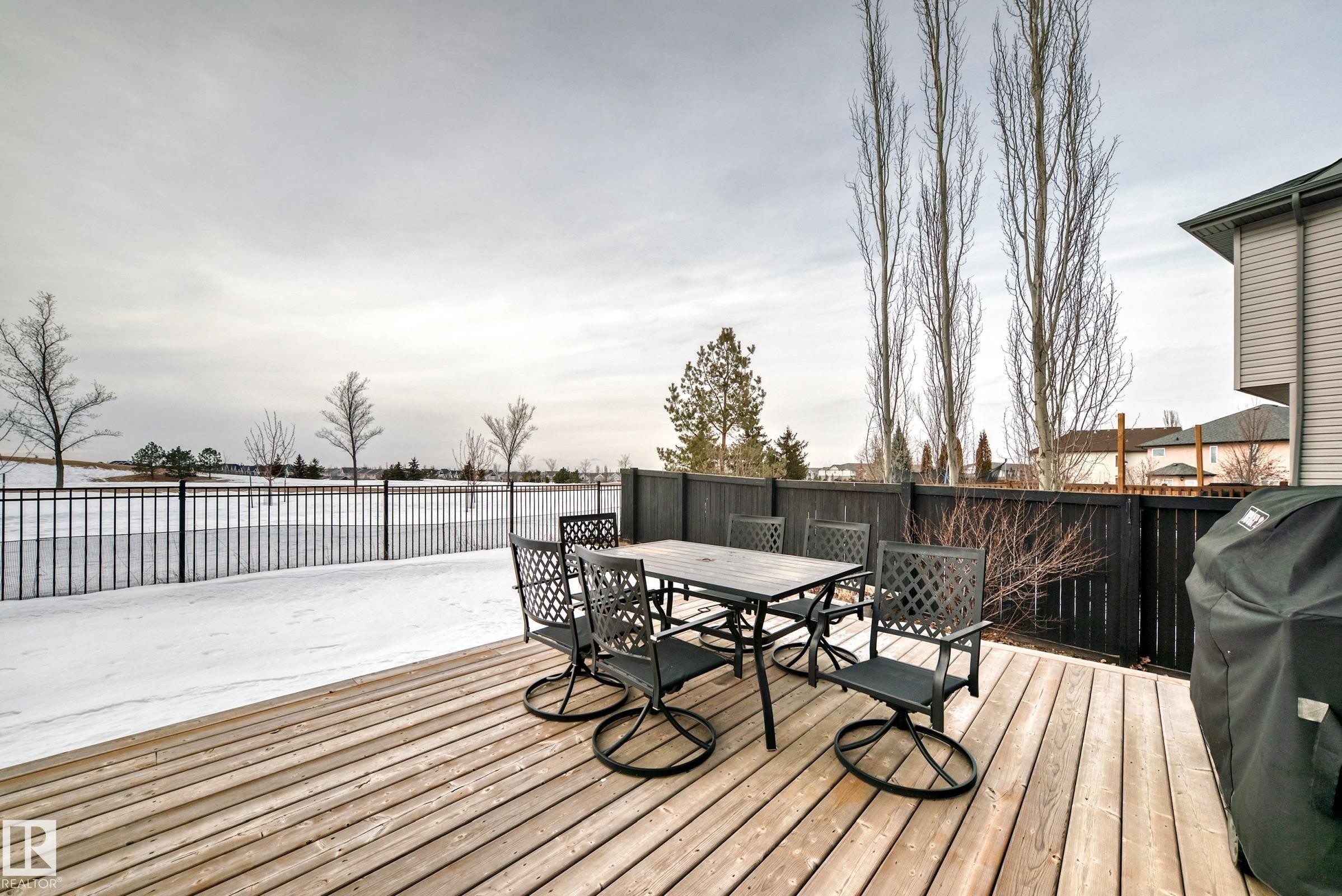 Wooden deck featuring grilling area, a fenced backyard, and outdoor dining area - 1908 69 Street, Edmonton, AB - Outdoor With Deck Patio Veranda With Exterior